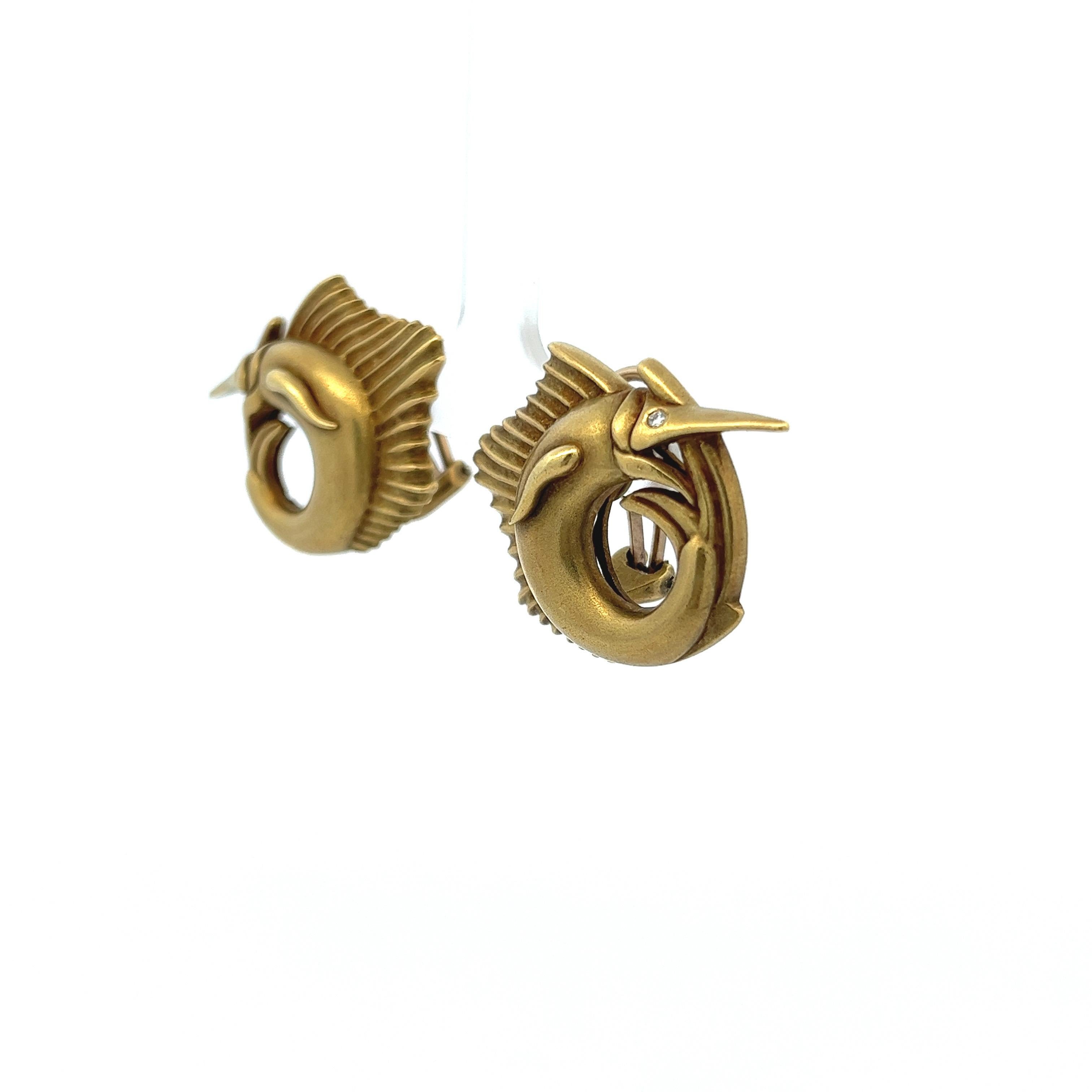 The Barry Kieselstein-Cord Marlin Clip-On Earrings exemplify distinguished design and quality craftsmanship. Rendered in 18K yellow gold, they feature a detailed depiction of a marlin, each of its eyes adorned with a .02 carat diamond. The earrings