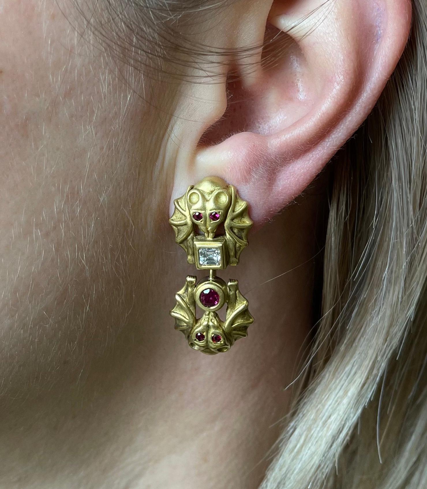 Pair of rare and unique 18k gold earrings, crafted by Barry Kieselstein-Cord, depicting bats, adorned with vibrant rubies and approx. 0.60ctw G/VS diamonds. Earrings have detachable drops, can be worn two ways. Earrings measure 1.5