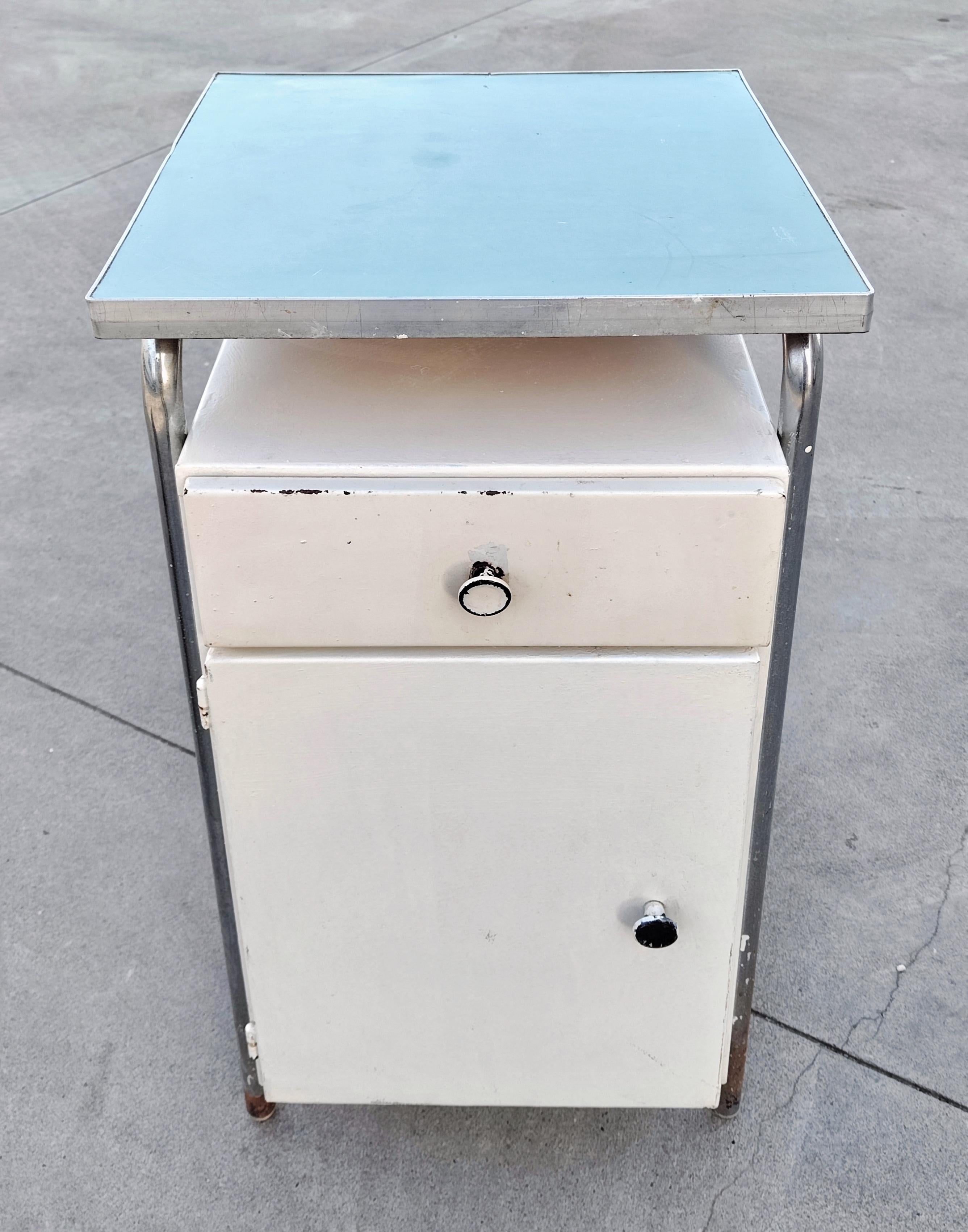 In this listing you will find a very rare Bauhaus bedside table or cabinet used in hospitals. It is done in metal and it features a small cabinet and a drawer, with the board done in sky blue plywood. Made in Yugoslavia in 1930s.

Good vintage