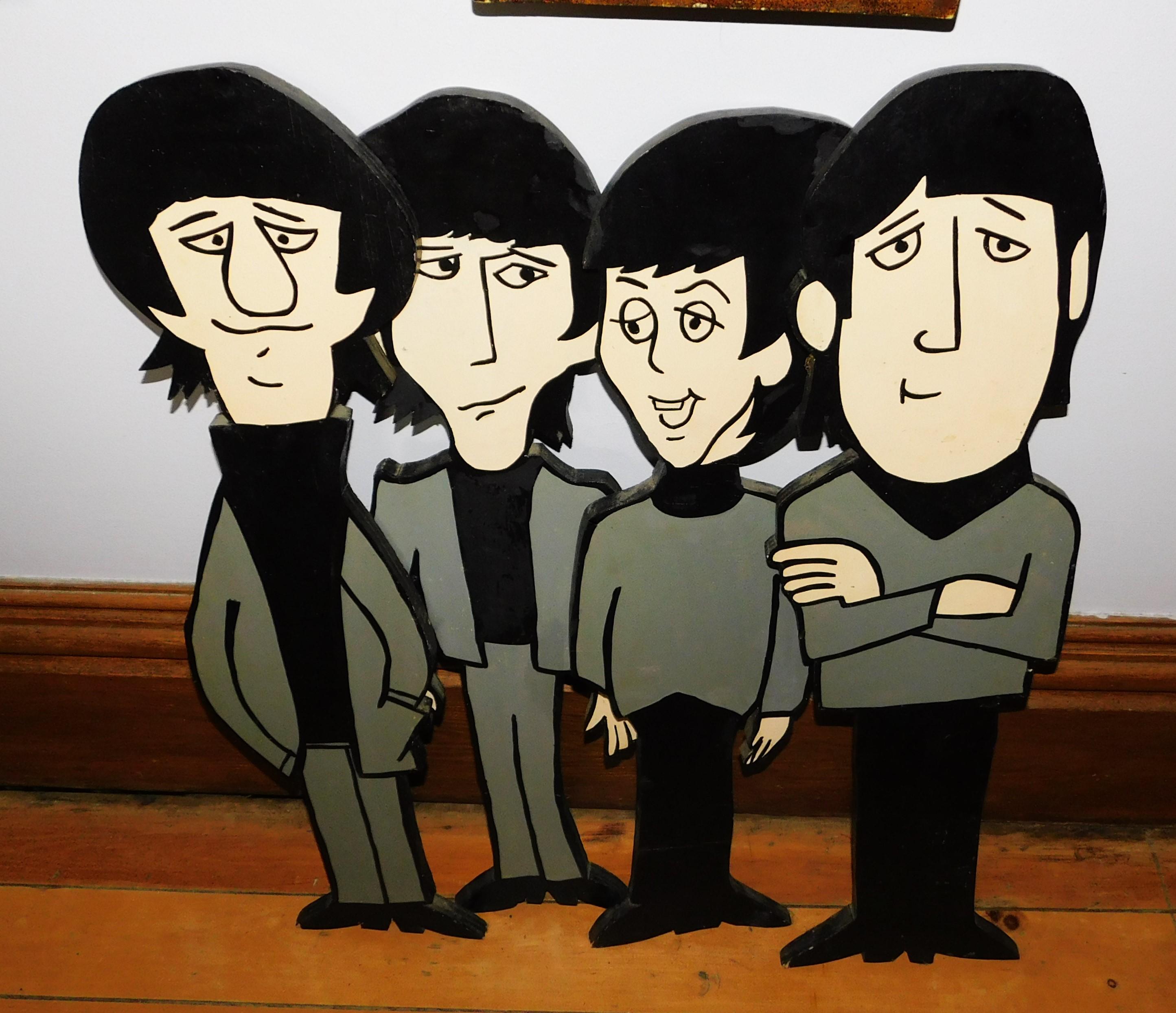 These four rare Beatle wooden Stand up cutouts are as the Fab Four as they appeared in the Cartoon TV series that ran from 1965 to 1969. The figures are all-over two feet high, John Lennon is 26 inches, Paul McCartney is 24.5 inches, George Harrison