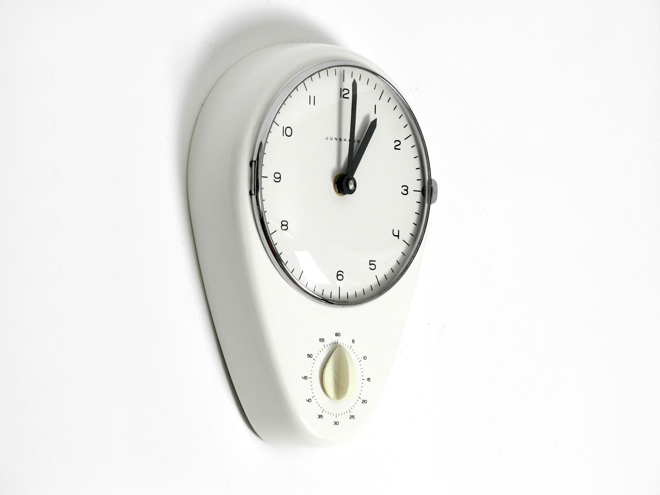 Very rare, beautiful battery-operated Mid Century wall clock by Max Bill for Junghans.
Max Bill was a very well-known Swiss architect, artist and industrial designer.
The housing is made of white glazed ceramic. Dial is covered by a curved real