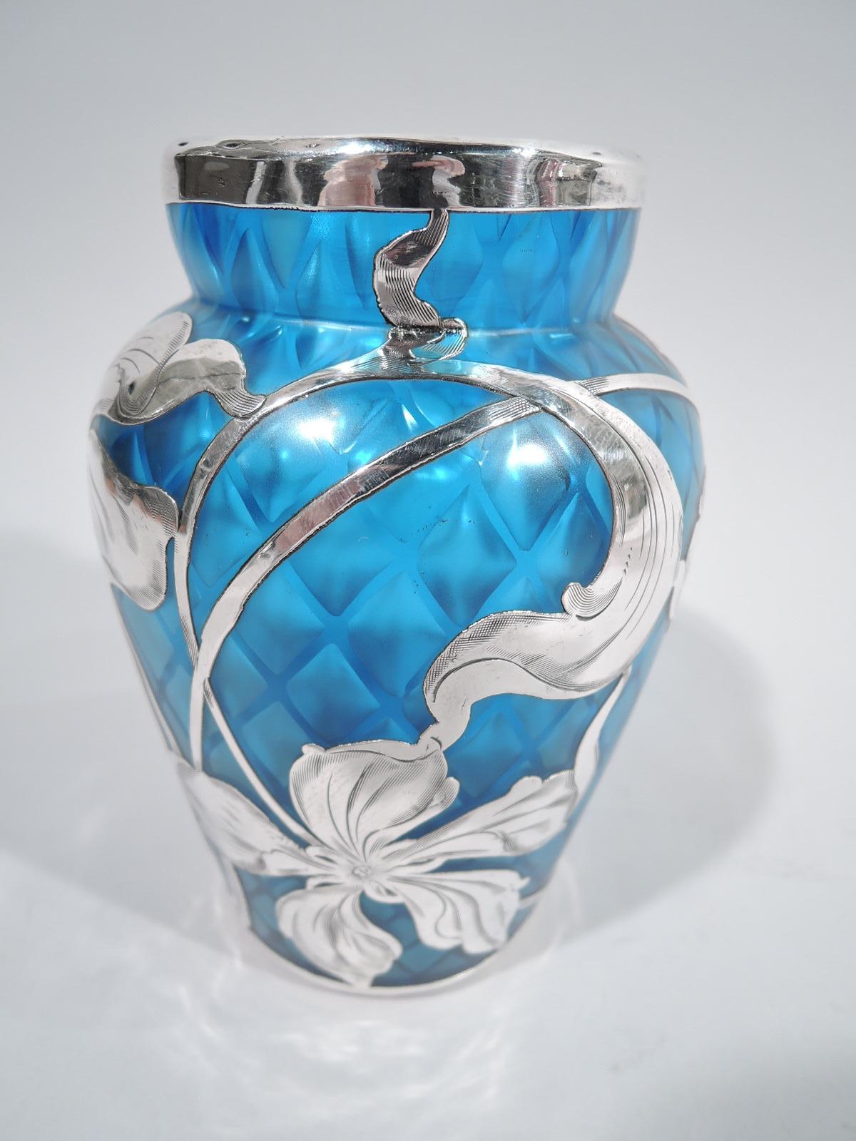 Beautiful turn-of-the-century Art Nouveau glass vase by historic maker Loetz with engraved silver overlay. Gently tapering sides and short inset neck. Loose and fluid floral overlay. An open and dynamic design with irregular petals and whiplash