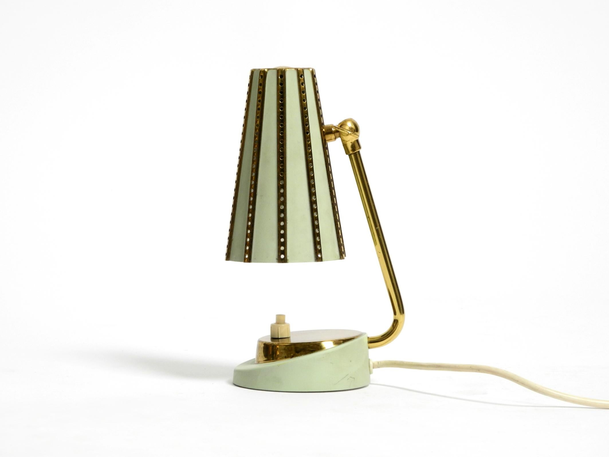 German Rare beautiful mid-century brass night table lamp with a perforated metal shade For Sale