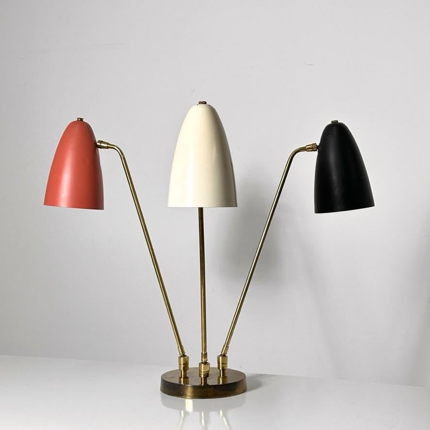 A rare three arm articulated table or desk lamp designed by Ben Seibel for Raymor circa 1950s
Brass base with three adjustable arms and tri color enameled pivoting shades in red white and black

All original very well preserved condition

23 inch