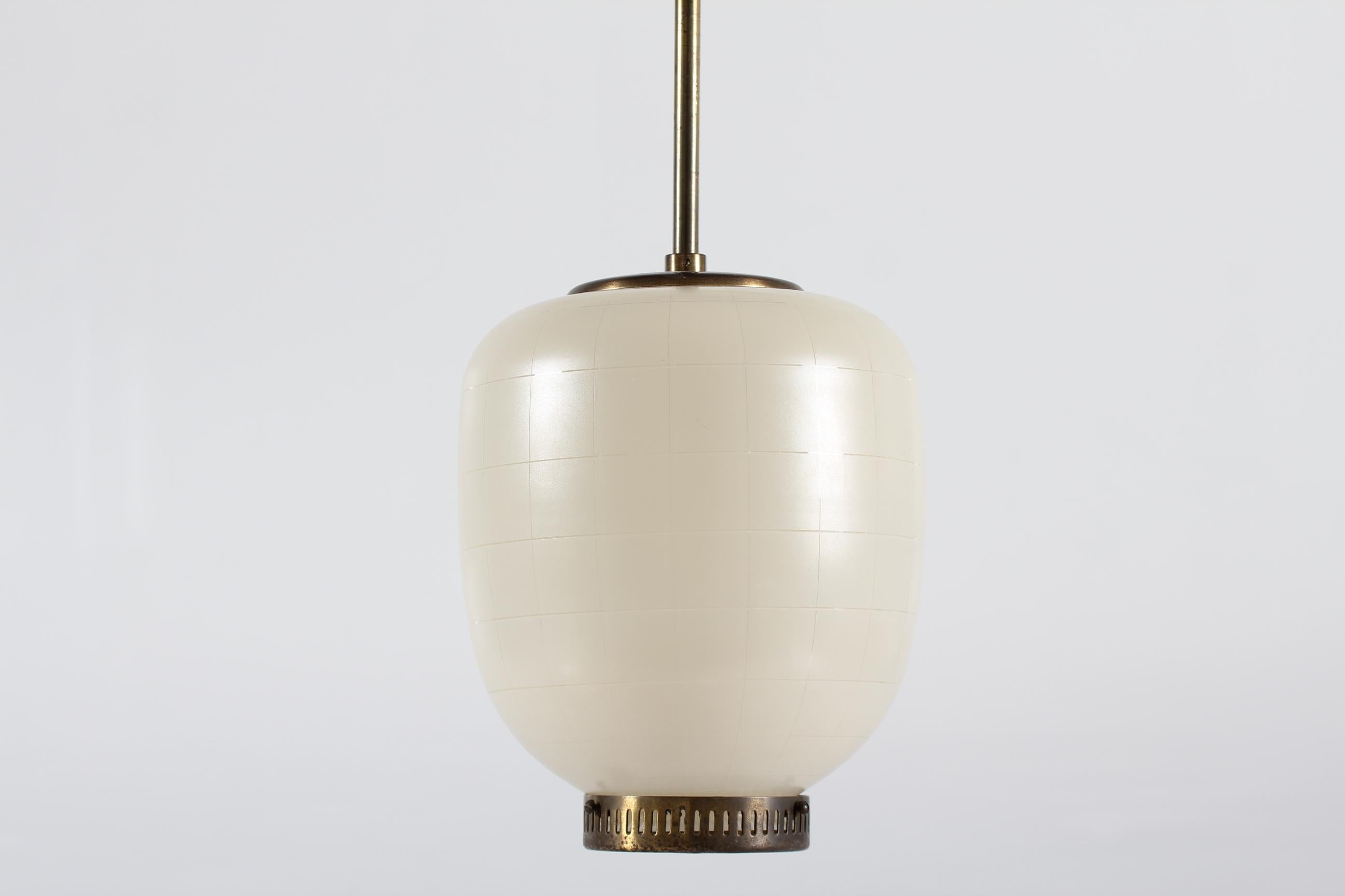 Rare edition of the China pendent made of off-white opaline glass with thin stripes and brass fittings.
It's designed by Danish Bent Karlby (1912-1998) and manufactured by the Danish lamp company Lyfa in Copenhagen in the 1960´s.

Very nice