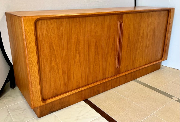 Stunning and rare teak credenza by famed Bernhard Pedersen and Son.
Features tambour doors that slide open top plenty of storage. Center drawers have felt padding for your flatware or jewelry.  Great scale and clean Danish Modern lines. Why not own
