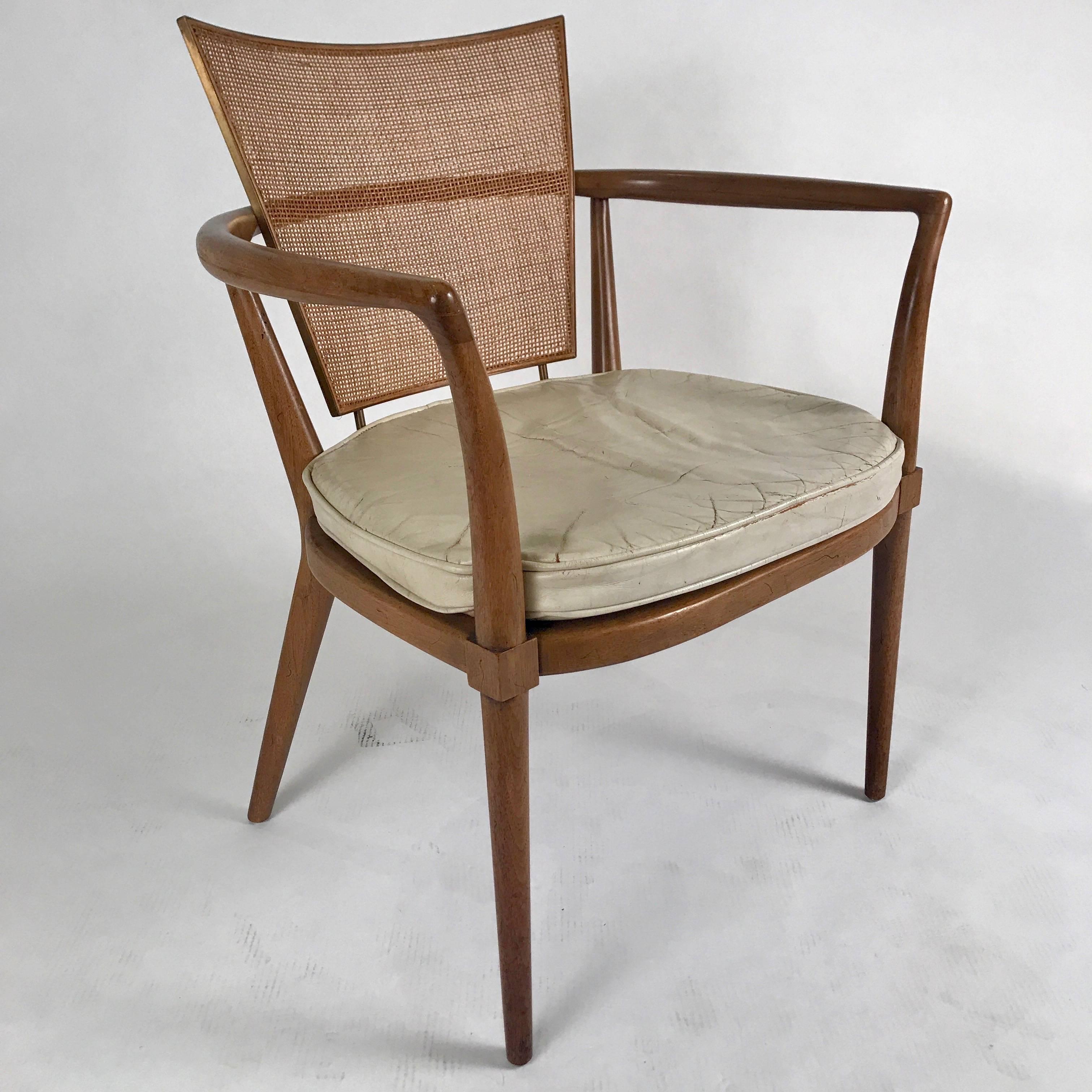 Stunning, sculptural armchair designed by Bert England for Johnson Furniture. Sturdy frame of fruitwood with finely caned seat back on a solid brass frame.
 