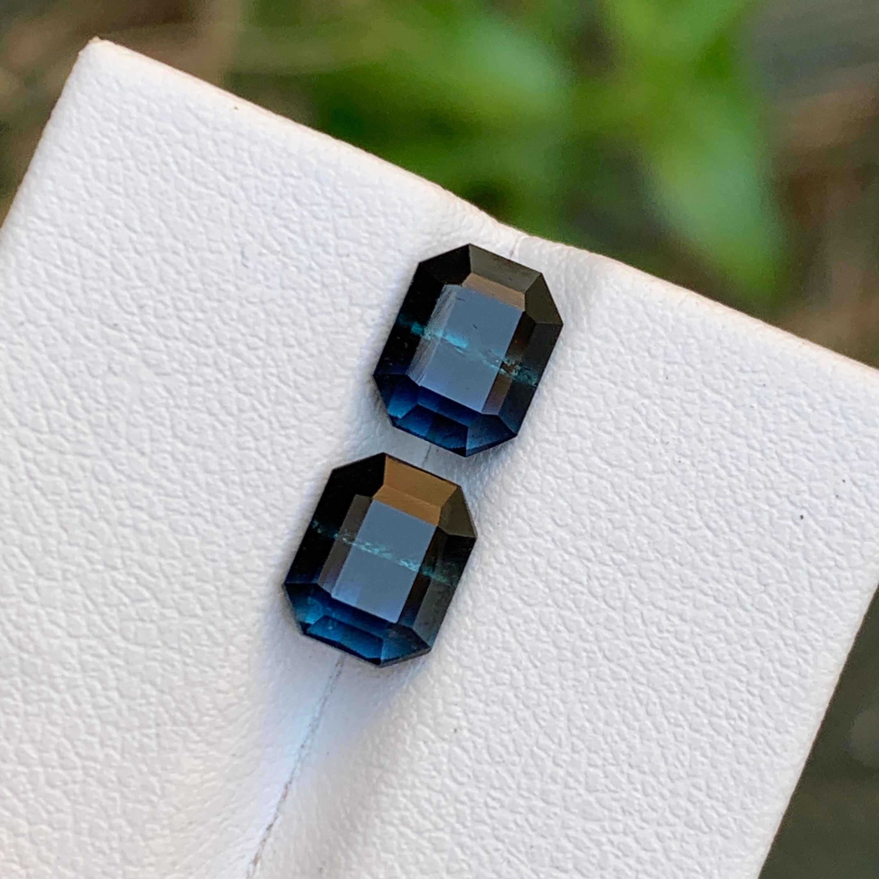 GEMSTONE TYPE: Tourmaline
PIECE(S): Pair
WEIGHT: 3.70 Carats
SHAPE: Emerald
SIZE (MM): 
1.85 Carat: 7.63 x 6.08 x 4.75
1.85 Carat: 7.56 x 6.18 x 4.96
COLOR: Bicolor Blue and Black
CLARITY: Slightly Included 
TREATMENT: None
ORIGIN: