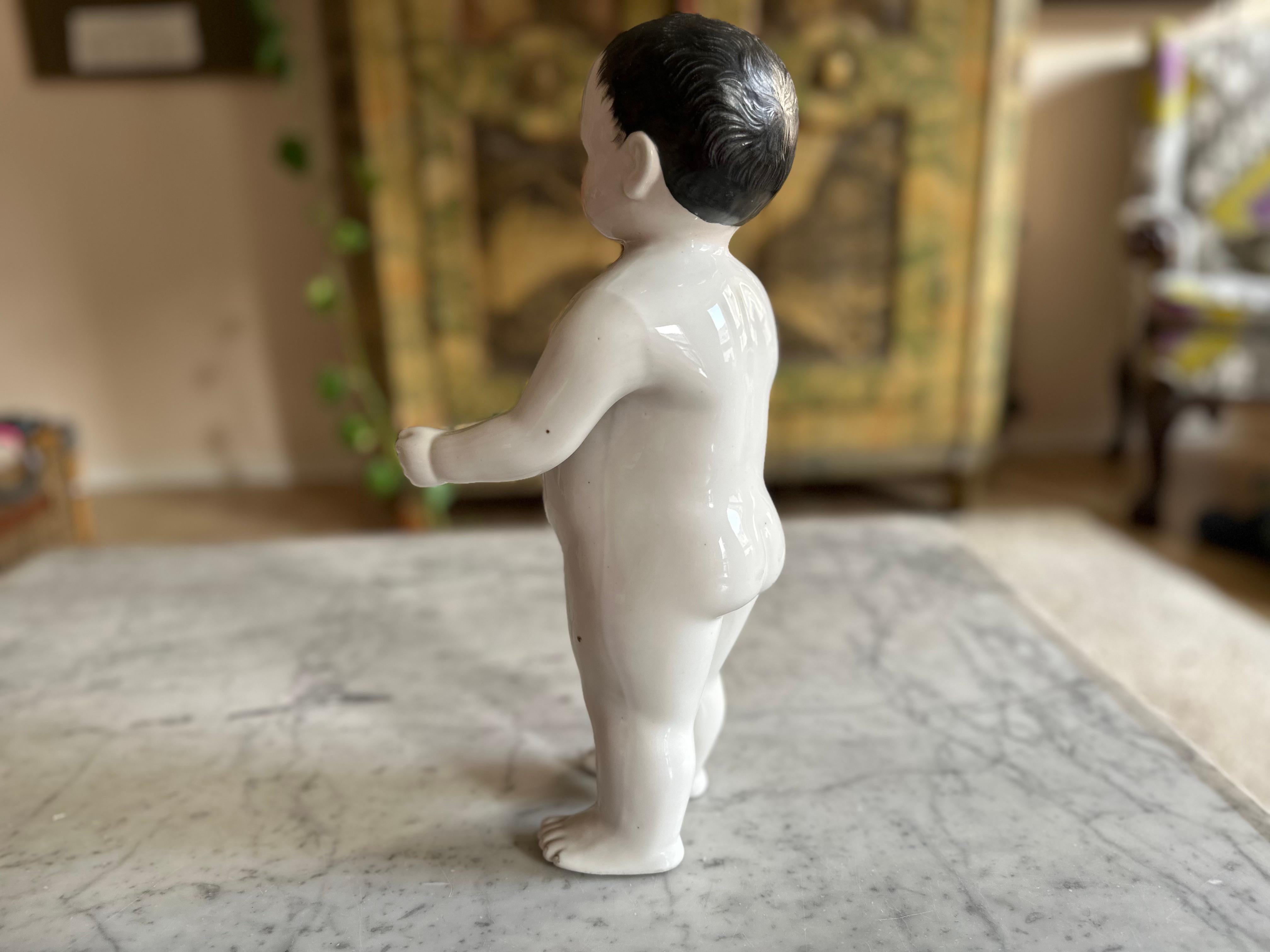 This exquisite Biedermeier porcelain bathing doll, dating back to around 1820, is a fascinating piece of early toy history. During the 19th century, these dolls were used as floating bath toys for children, despite their delicate and fragile