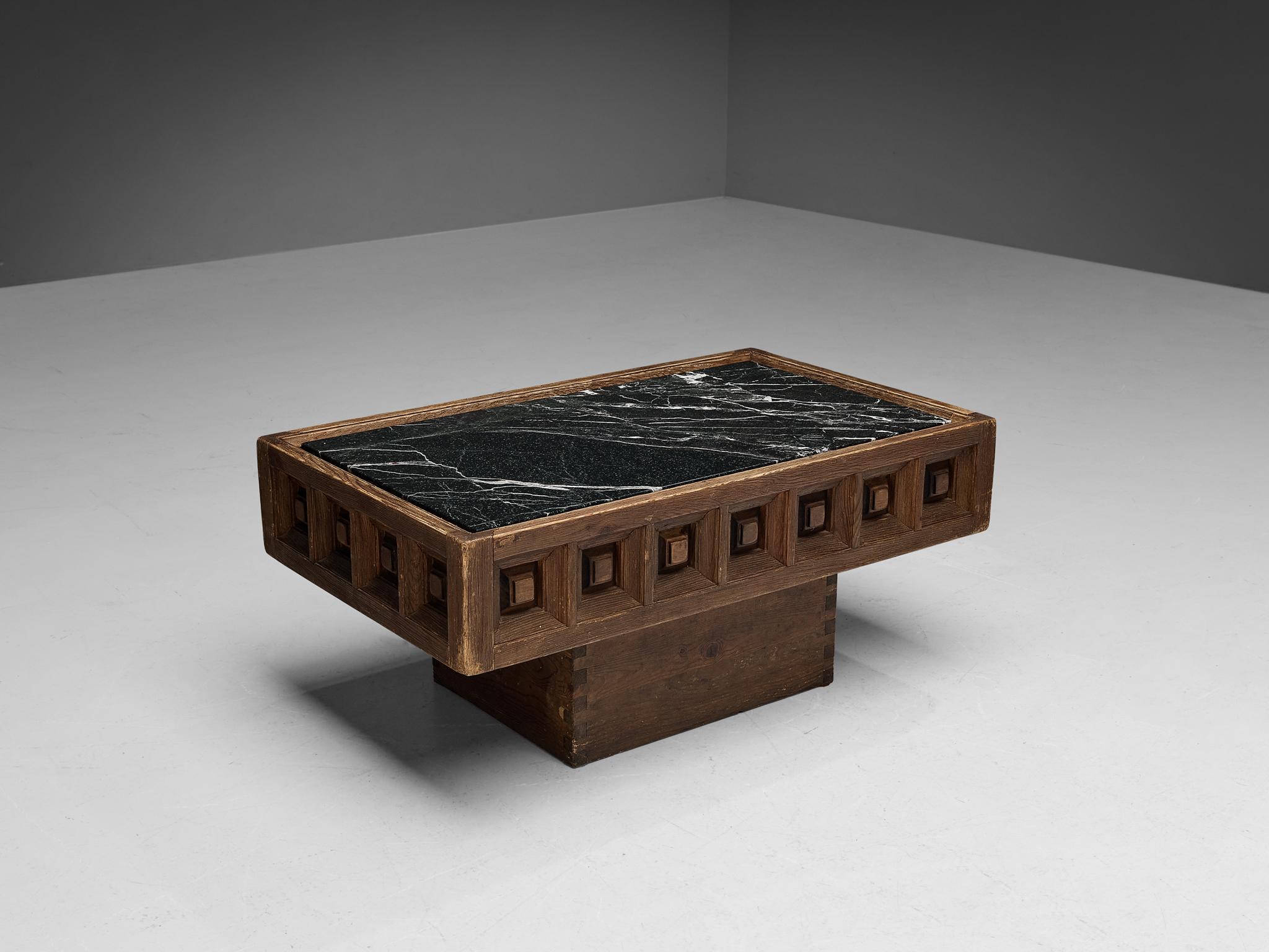 Biosca, coffee table, stained pine, Marquina marble, Spain, 1960s.

Outstanding Spanish coffee table that is executed by Biosca in an architectural way. The tabletop features a relief border of carved squares, giving the table a graphic texture.
