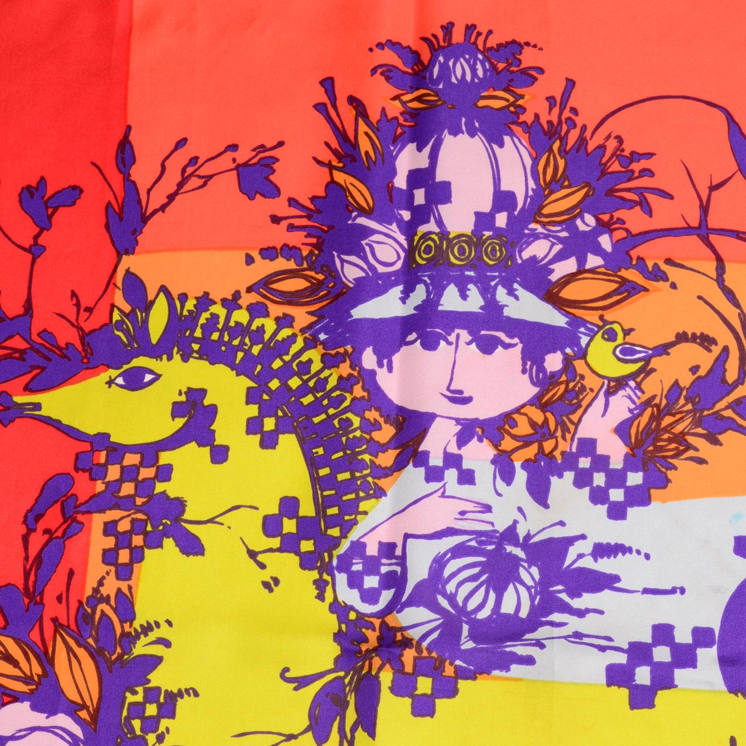 This is a very  rare 1970s vintage silk scarf was designed by Bjorn Wiinblad for the Neiman Marcus Library of Fashion series. The scarf has a woman on a horse in purple, pink, and yellow, and the background is is beautiful shades of red, orange and