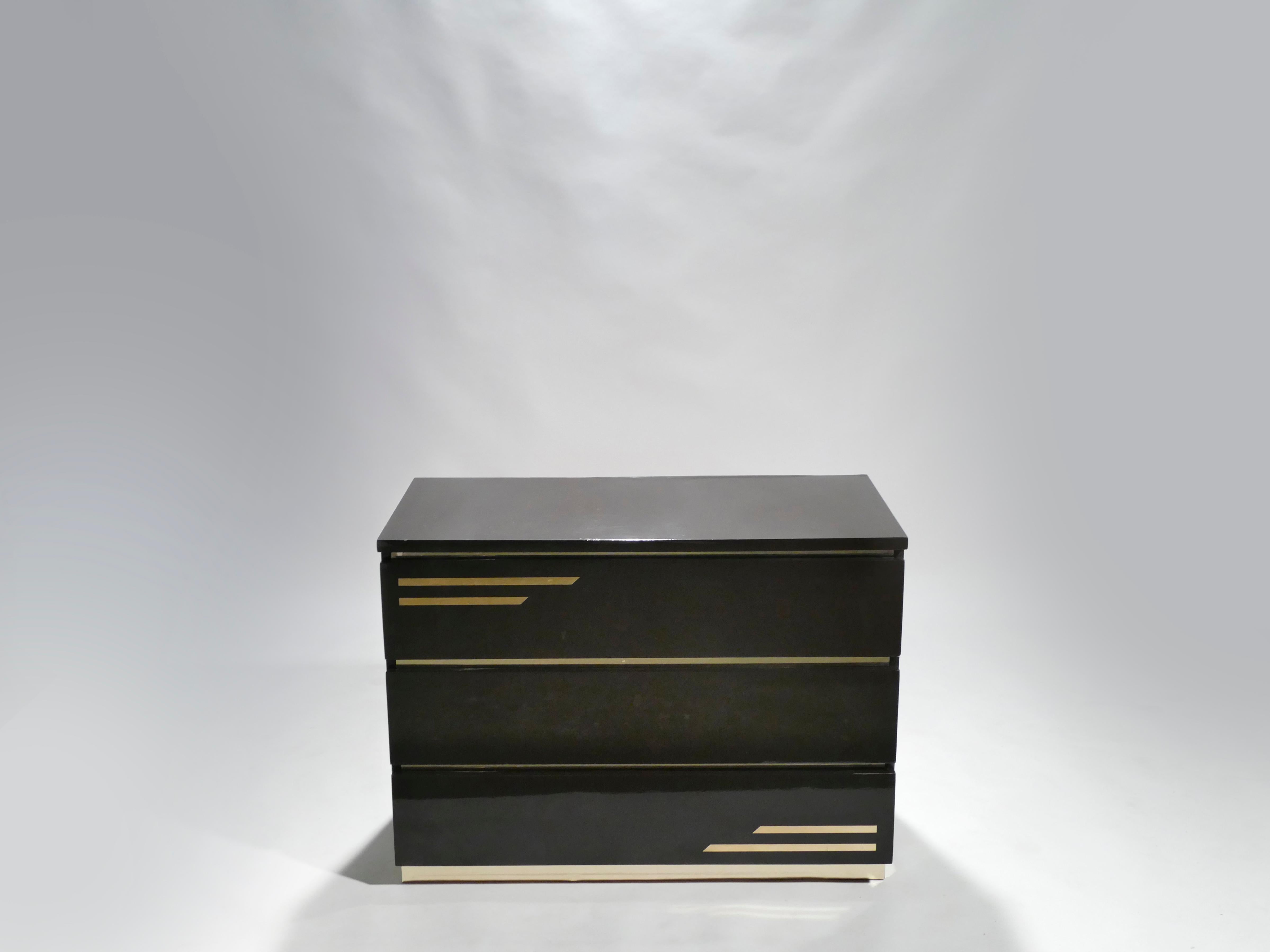 Crisp black lacquer, paired with bright brass accents, feels luxurious on this chest of drawers. It’s boxy, simple style is typical of both the 1970s and French designer Jean Claude Mahey. Whether used in a bedroom, living room or entrance, this