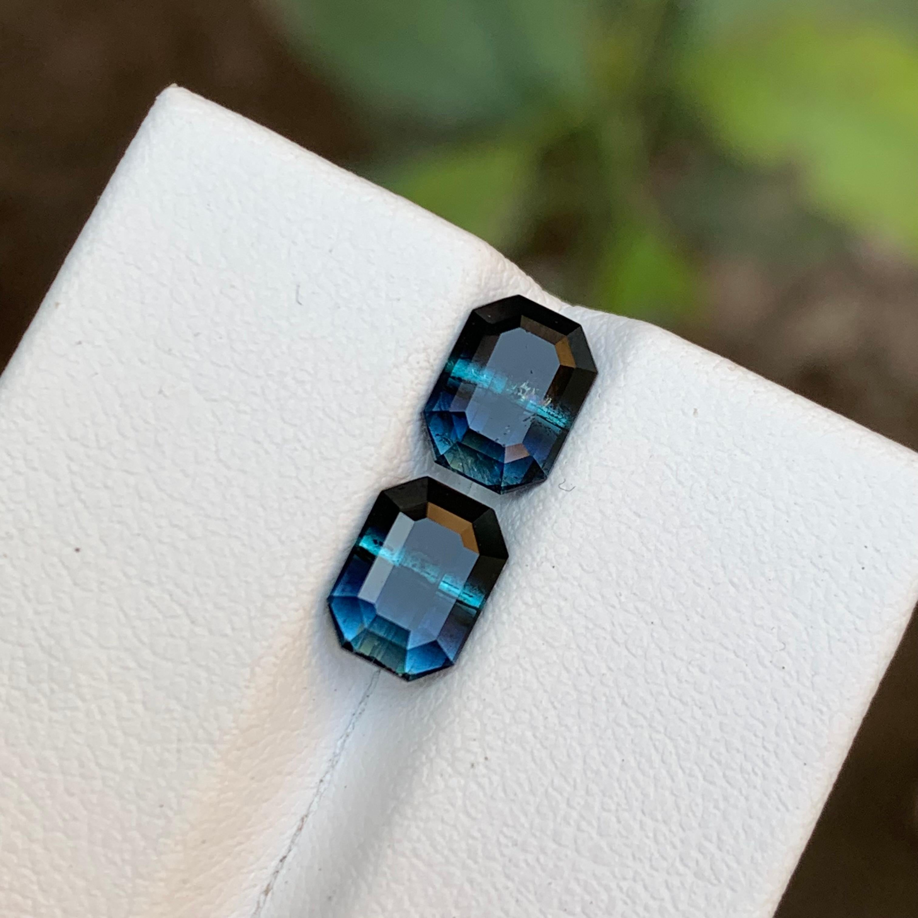 GEMSTONE TYPE: Tourmaline
PIECE(S): Pair
WEIGHT: 2.75 Carats
SHAPE: Emerald
SIZE (MM): 
1.35 Carat: 7.60 x 5.67 x 3.85
1.40 Carat: 7.56 x 5.63 x 3.94
COLOR: Bicolor Black and Blue
CLARITY: Slightly Included
TREATMENT: None
ORIGIN: