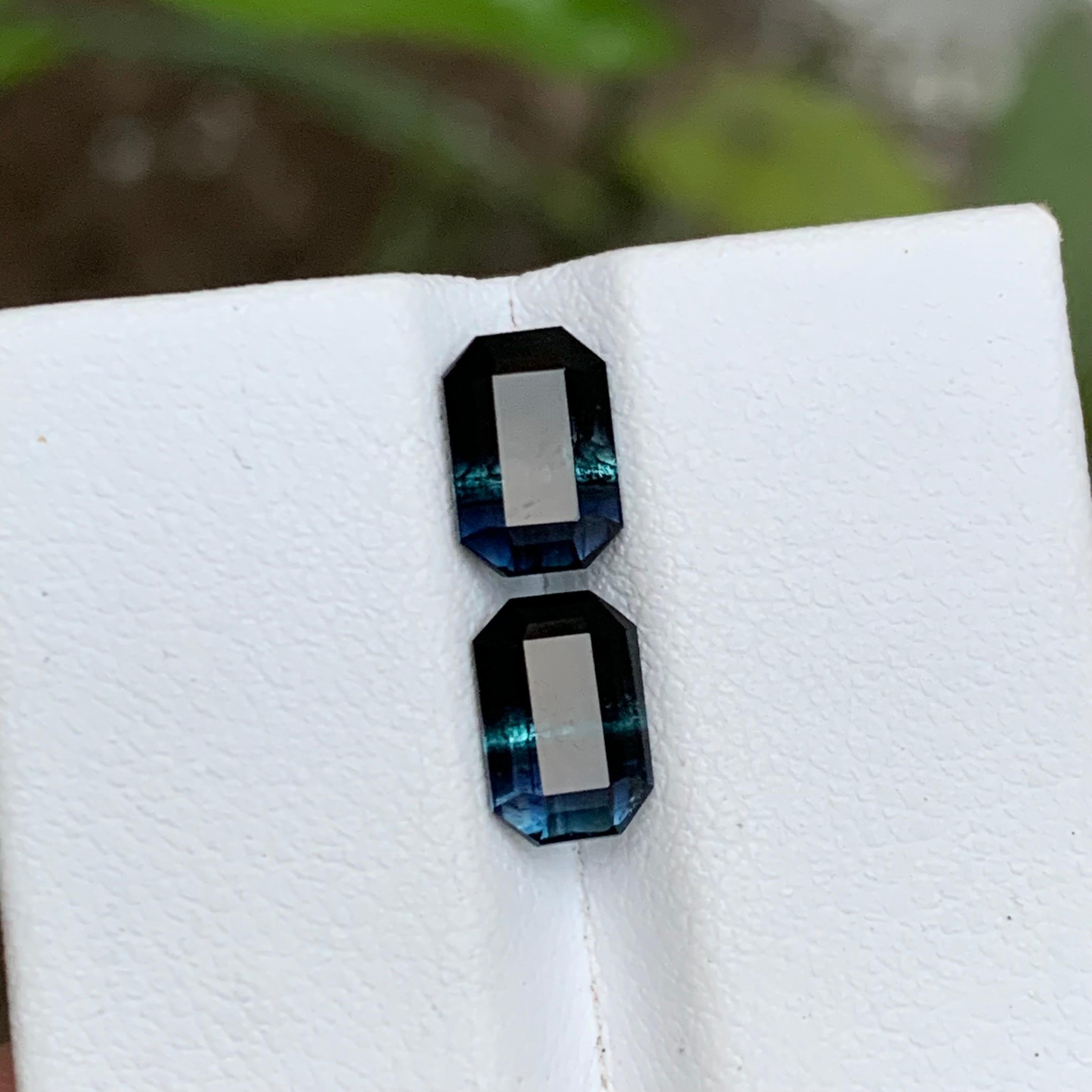 GEMSTONE TYPE: Tourmaline
PIECE(S): Pair
WEIGHT: 2.75 Carats
SHAPE: Emerald
SIZE (MM): 
1.45 Carat: 7.88 x 5.36 x 3.88
1.30 Carat: 7.91 x 5.32 x 3.54
COLOR: Bicolor Black and Blue
CLARITY: Slightly Included
TREATMENT: None
ORIGIN: