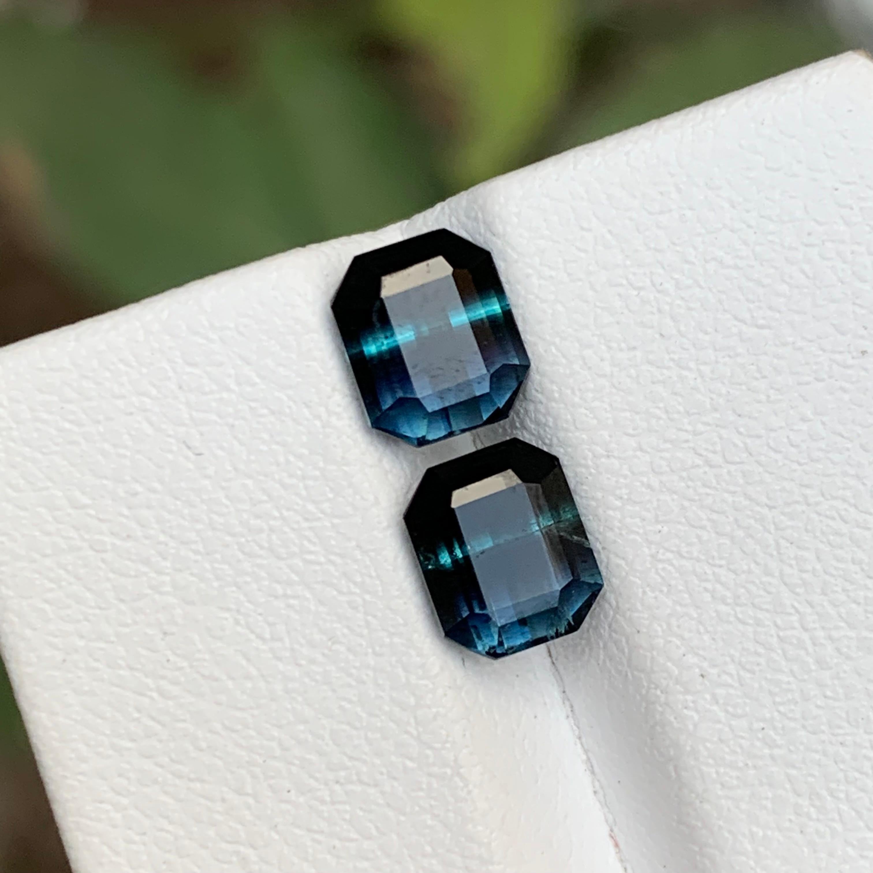 GEMSTONE TYPE: Tourmaline
PIECE(S): Pair
WEIGHT: 3.25 Carats
SHAPE: Emerald
SIZE (MM): 
1.60 Carat: 7.13 x 6.08 x 4.46
1.65 Carat: 7.13 x 5.92 x 4.58
COLOR: Bicolor Black and Blue
CLARITY: Slightly Included
TREATMENT: None
ORIGIN: