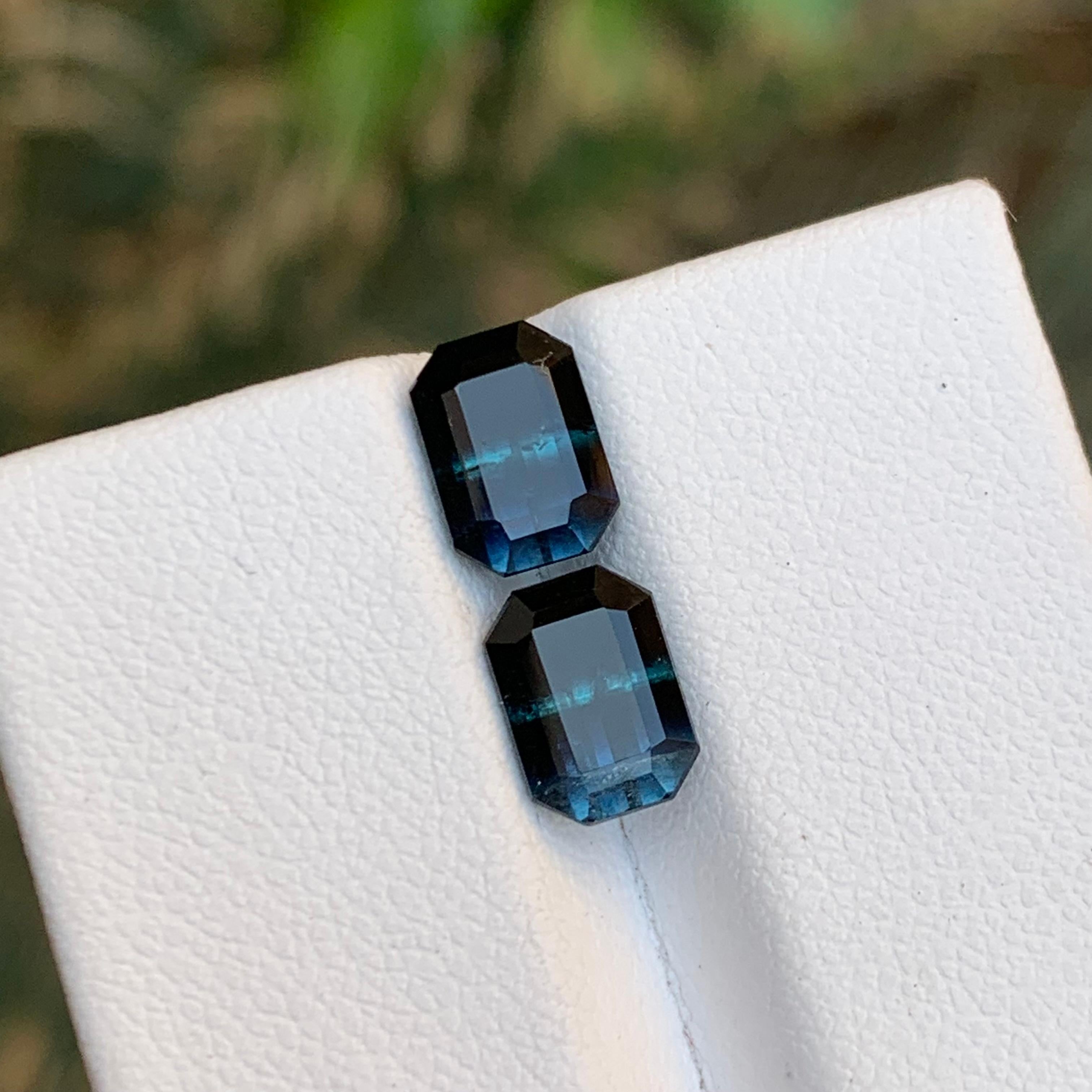 GEMSTONE TYPE: Tourmaline
PIECE(S): Pair
WEIGHT: 3.40 Carats
SHAPE: Emerald
SIZE (MM): 
1.70 Carat: 7.86 x 5.52 x 4.53
1.70 Carat: 7.85 x 5.62 x 4.56
COLOR: Bicolor Black and Blue
CLARITY: Slightly Included
TREATMENT: None
ORIGIN: