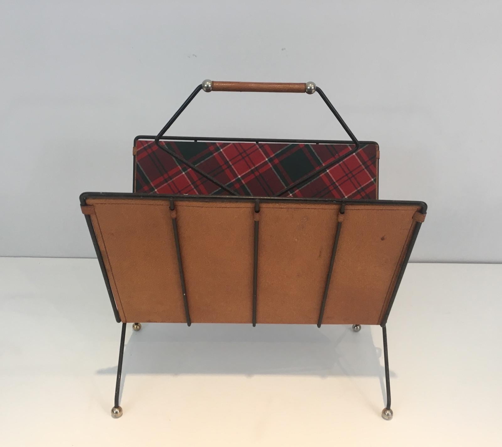 This rare magazine rack is made of fabric and leather on a black lacquered metal base, plaid fabric. This is a very nice French work, circa 1950.