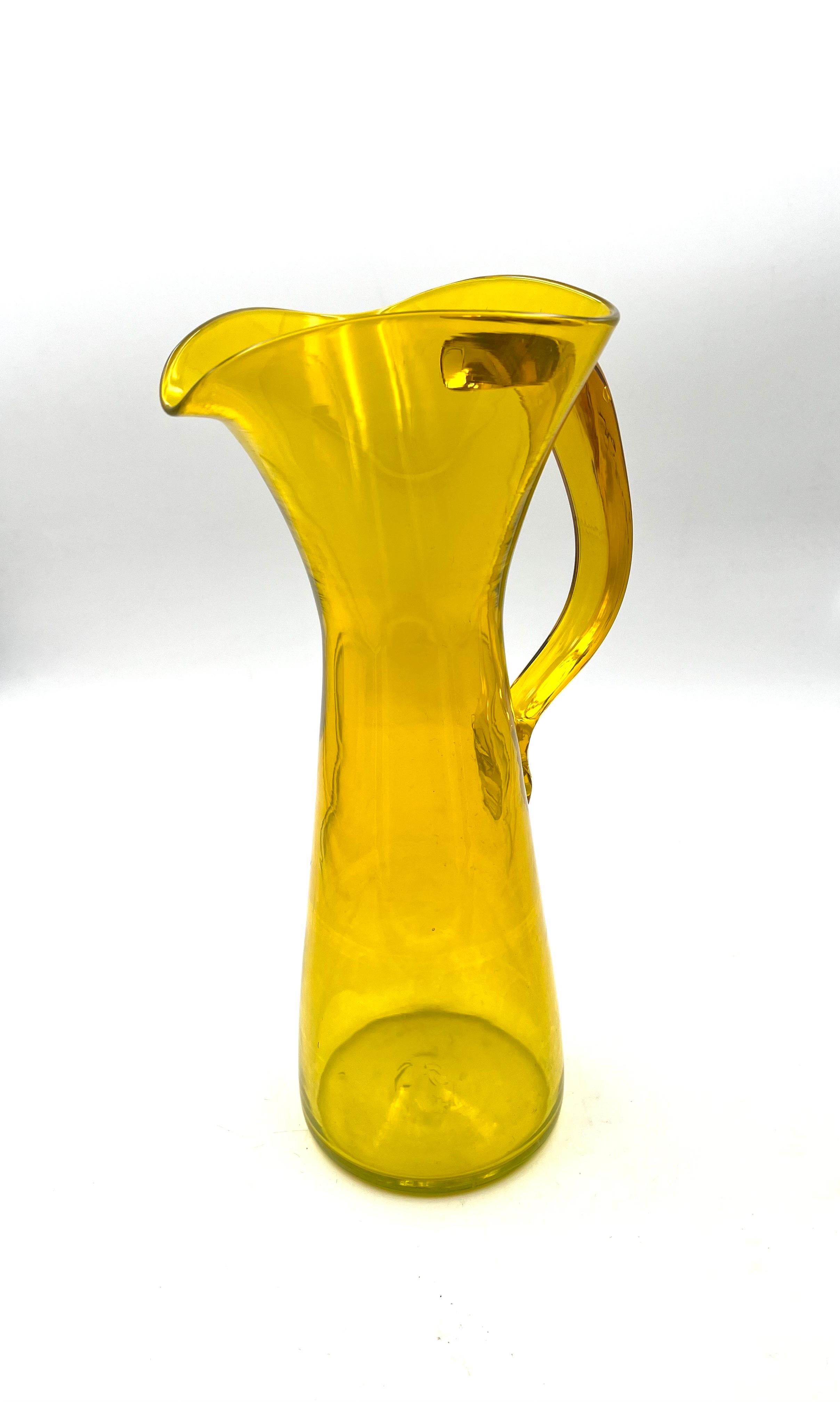 Beautiful color and excellent condition on this tall glass pitcher. by Blenko.