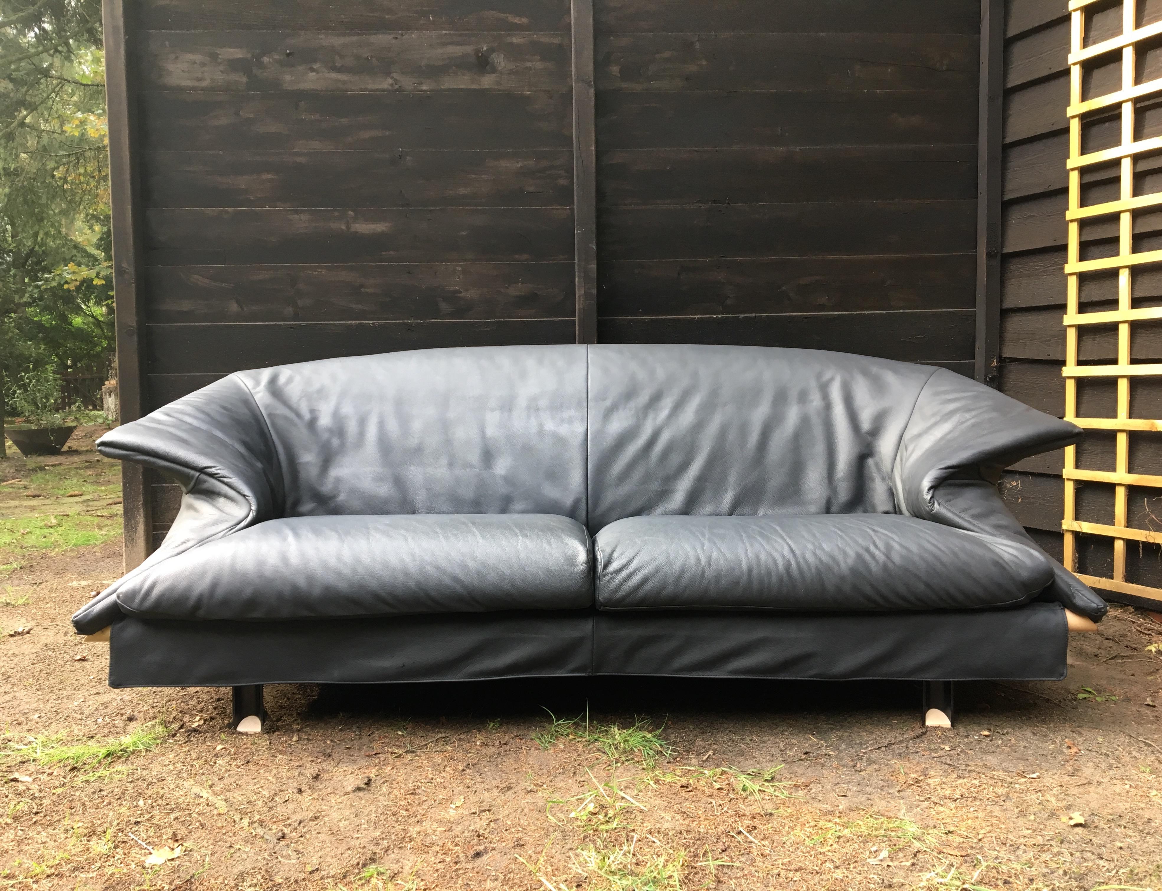 Striking anthracite / Dark Blue / Grey Leather sofa manufactured by Saporiti circa1980s. Its design is definitely inspired by designs of the Memphis Group. The sofa remains in fair condition, with some discoloration (mostly when cushions are being
