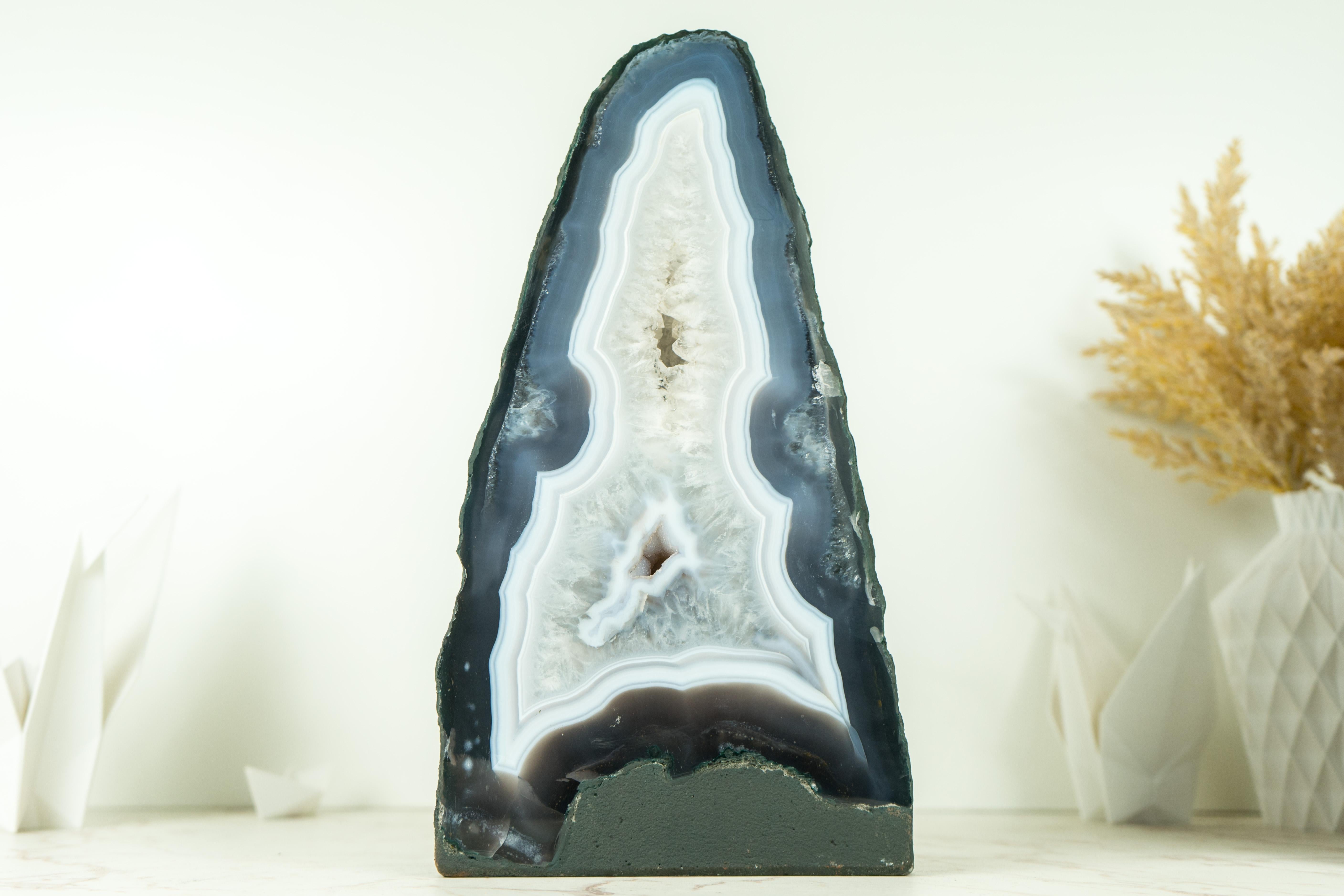A gorgeous, intact agate with blue and white laces, this agate geode is considered to be of super-extra quality due to its beauty, formation, and the aesthetical agate bands that surround the entire geode. An outstanding agate, this geode is sure to