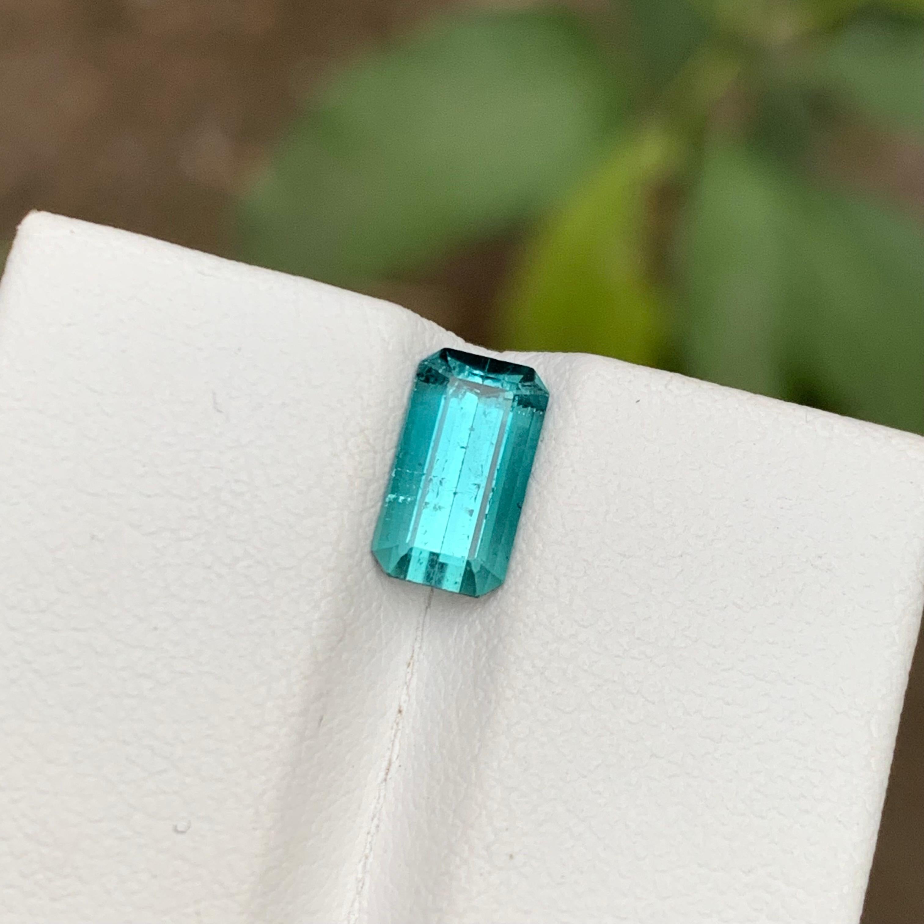 GEMSTONE TYPE: Tourmaline
PIECE(S): 1
WEIGHT: 1.60 Carats
SHAPE: Emerald Cut
SIZE (MM): 8.91 x 5.04 x 4.08
COLOR: Blue
CLARITY: Slightly Included 
TREATMENT: None
ORIGIN: Afghanistan
CERTIFICATE: On demand

This stunning 1.60 carat natural blue