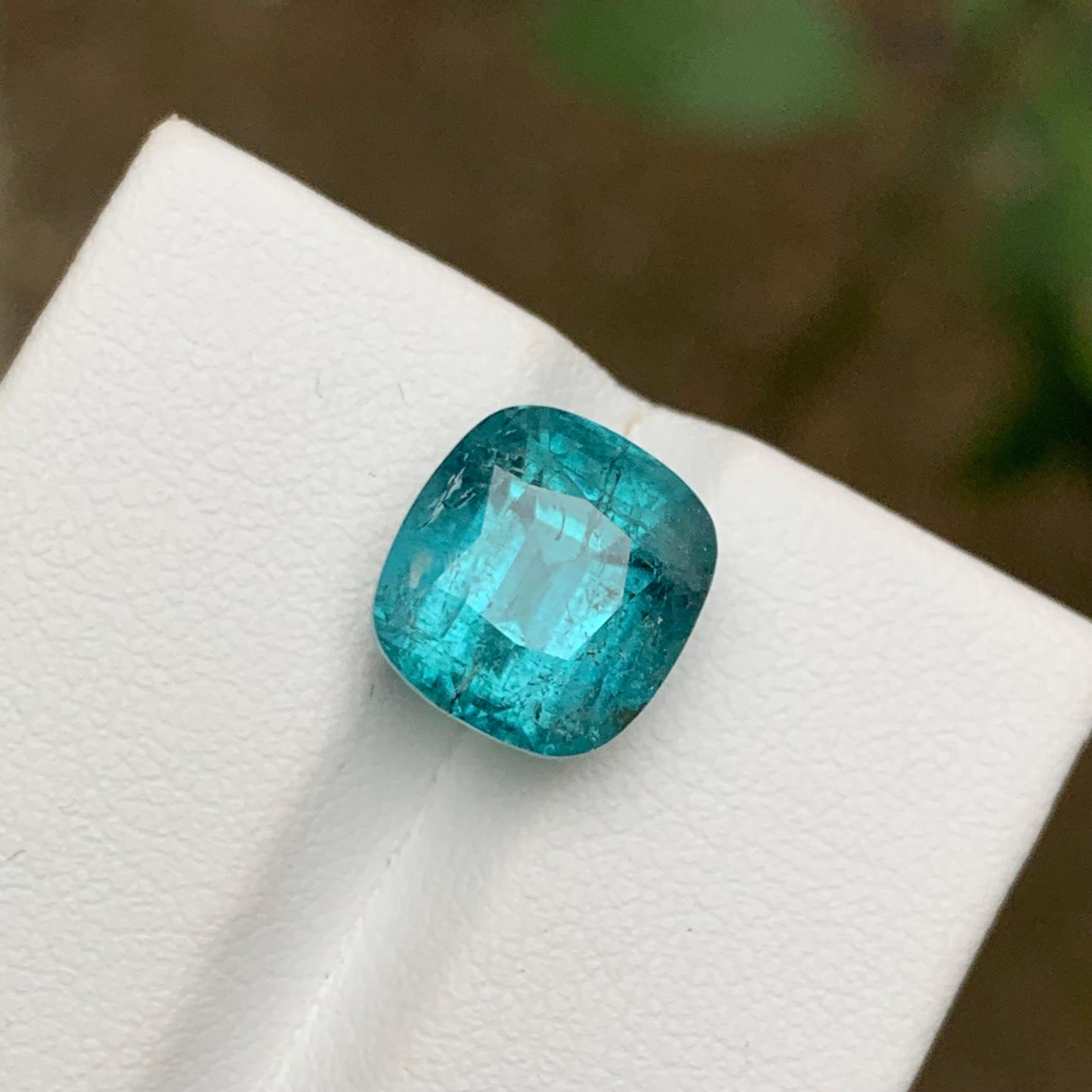 GEMSTONE TYPE: Tourmaline
PIECE(S): 1
WEIGHT: 6.25 Carats
SHAPE: Cushion Cut
SIZE (MM): 10.20 x 9.50 x 8.53
COLOR: Vibrant Blue
CLARITY: Moderately Included
TREATMENT: None
ORIGIN: Afghanistan
CERTIFICATE: On demand
(if you require a certificate,