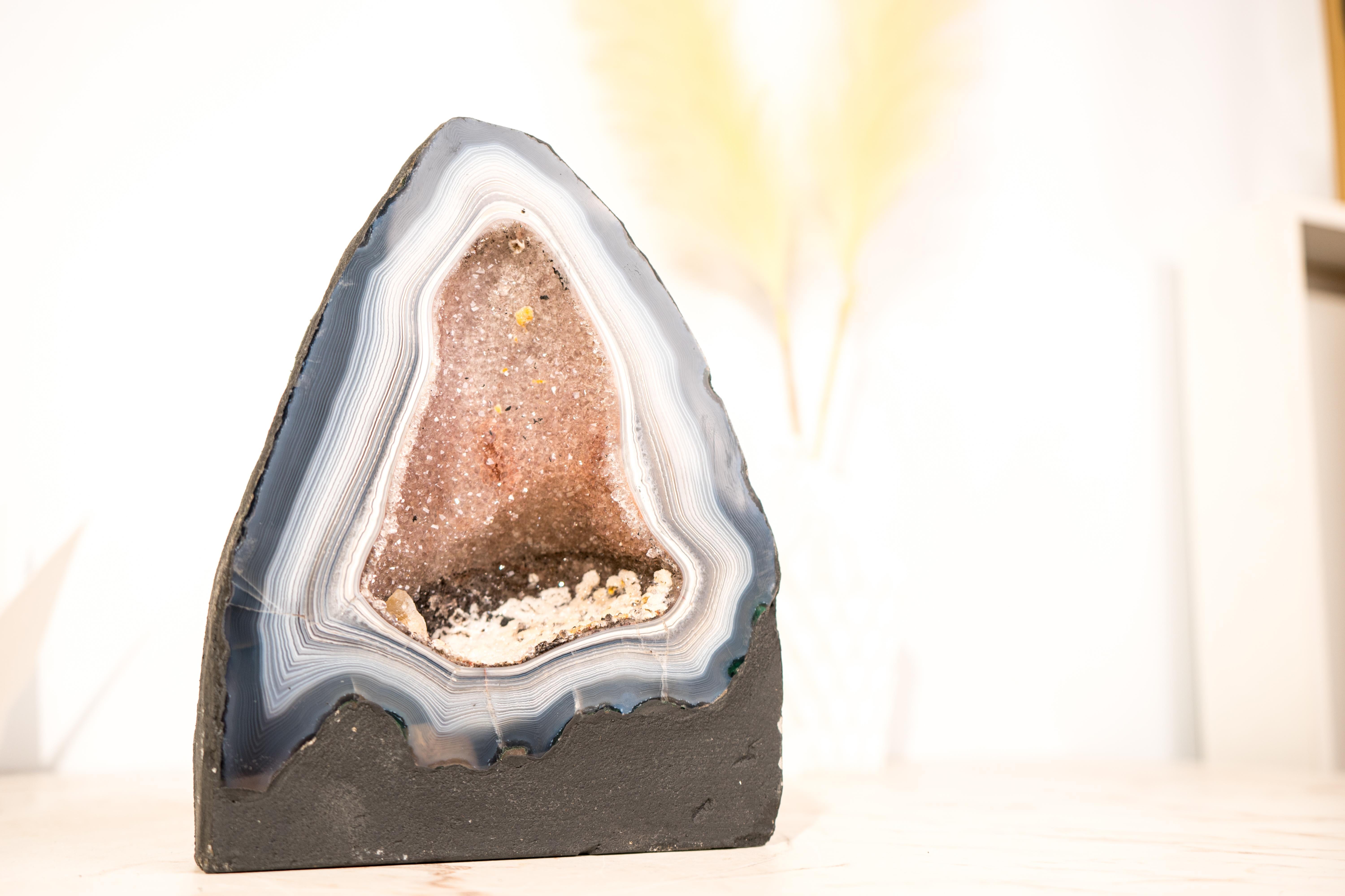 This uniquely rare, large, and beautiful agate geode will surely elevate your collection or space. It is a spectacular piece, meticulously cut open to showcase dozens of rarely-seen blue and white lace patterns—a true celebration of nature’s