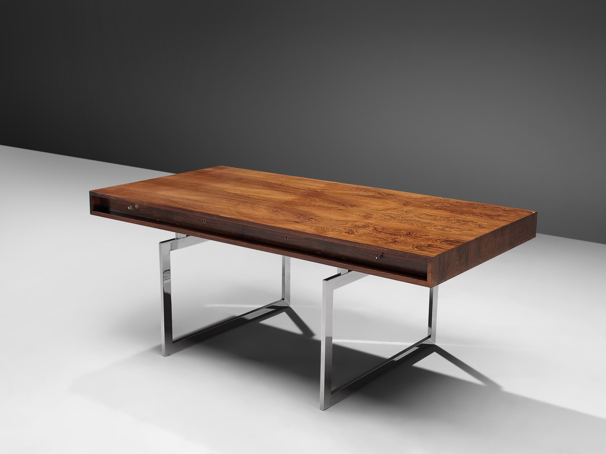 Bodil Kjaer for E. Pedersen & Søn, table model 901, Brasilian hardwood and chrome steel, Denmark, 1959.

This freestanding desk in rosewood is designed by the Danish designer Bodil Kjaer. The desk can be used with multiple purposes, as a writing
