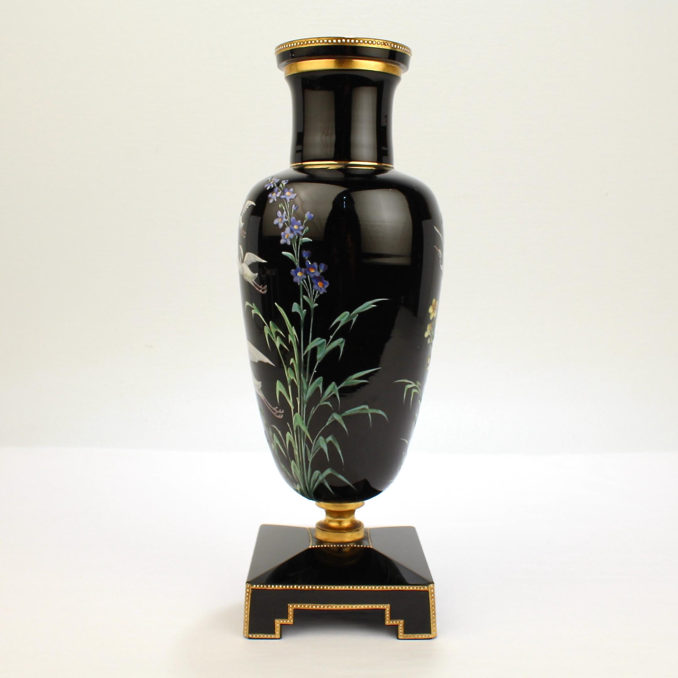A wonderful Victorian black amethyst art glass vase.

A terrific Bohemian Moser style vase with a stepped base and vasiform body. 

The body is decorated with hand painted enameled herons or storks in flight and a variety of flowers, and the