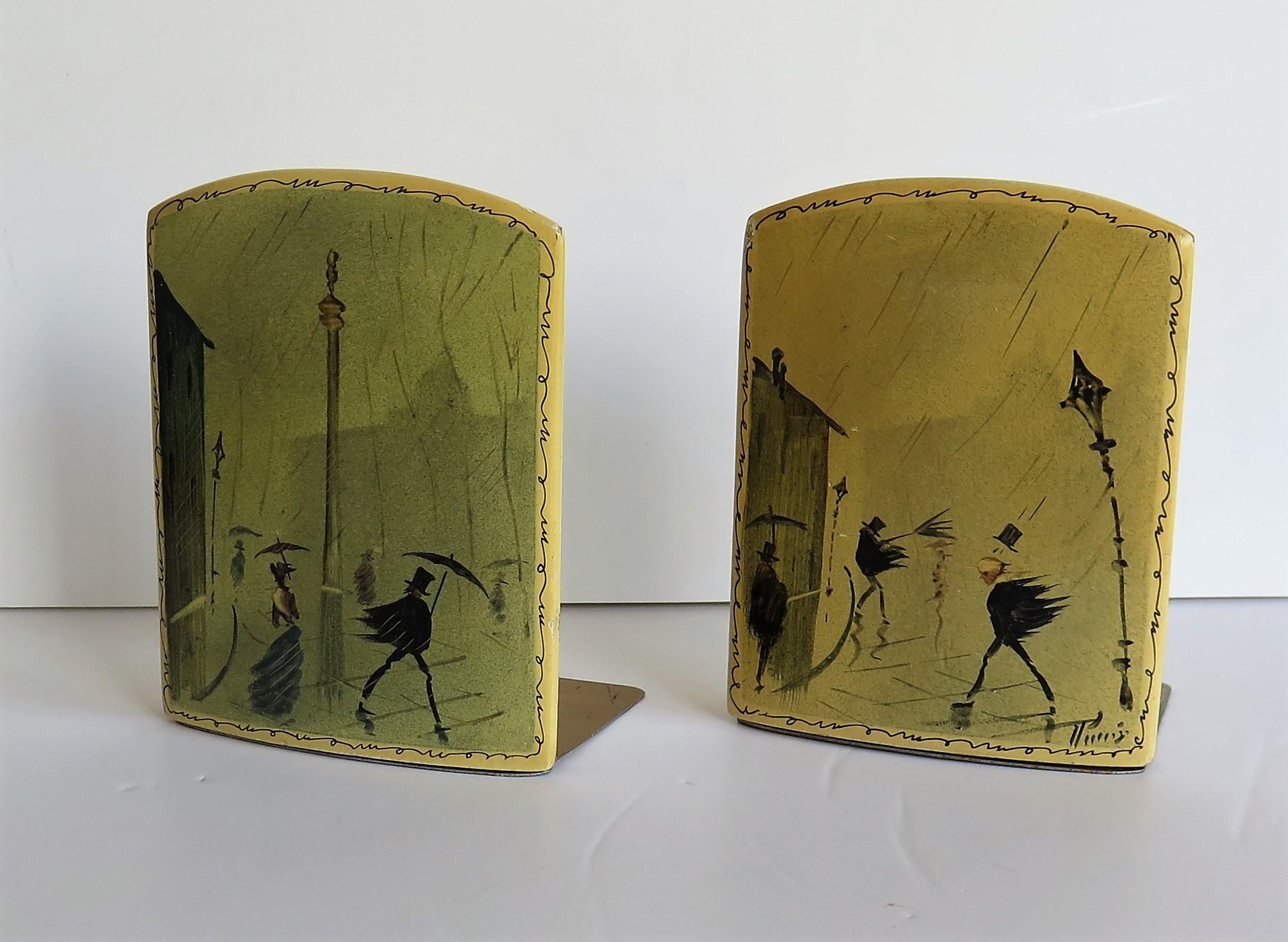 These are a beautiful, rare pair of French book ends, hand painted and signed, which we date to the late 19th century.

Each bookend has a hinged folding metal base section 

The bookends have been beautifully hand painted in a free flowing style,