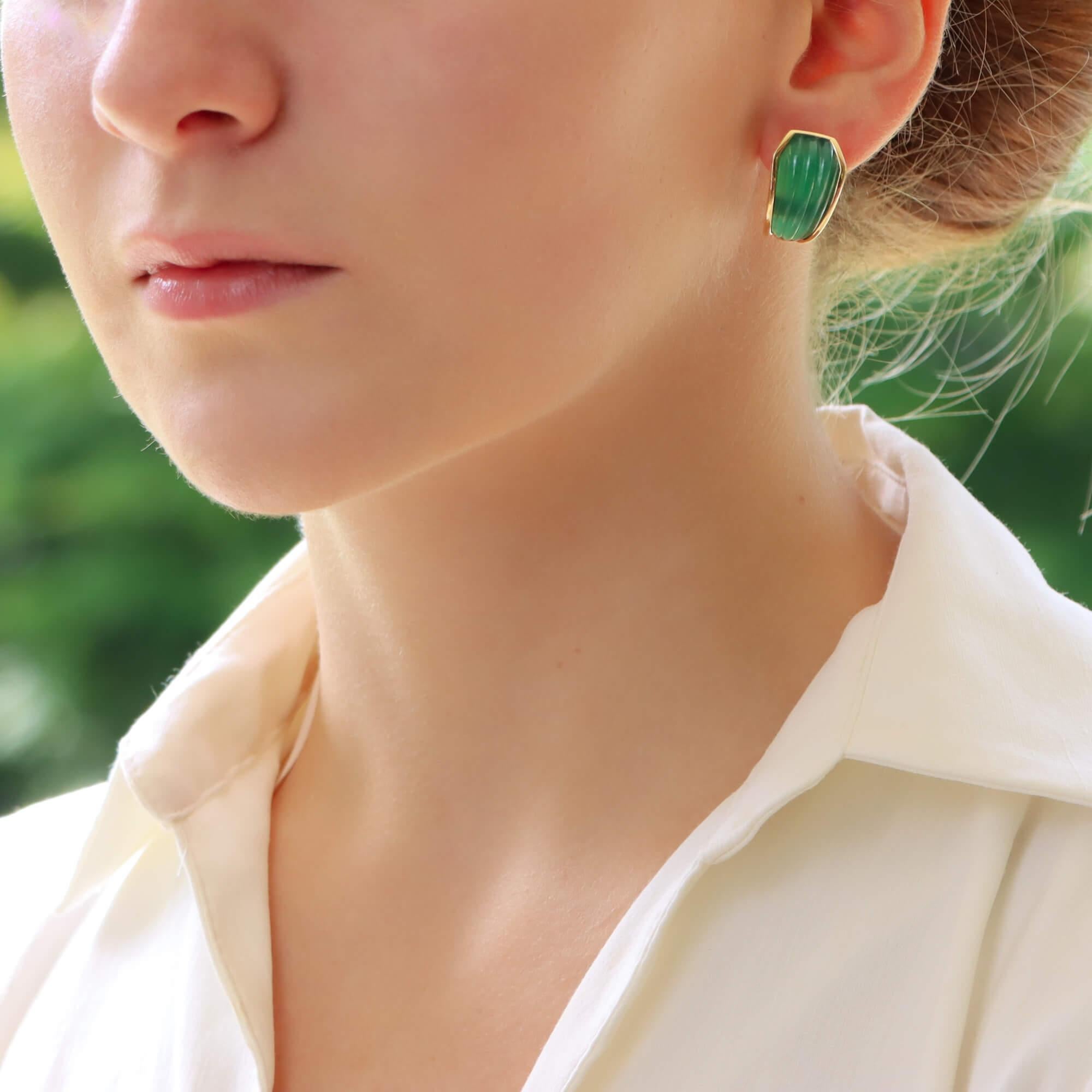 An extremely rare and beautiful pair of Boucheron chrysoprase (green chalcedony) clip on half hooped earrings set in 18k yellow gold. 

The pair are each set with a piece of vibrant green chrysoprase which have each been individually carved into a