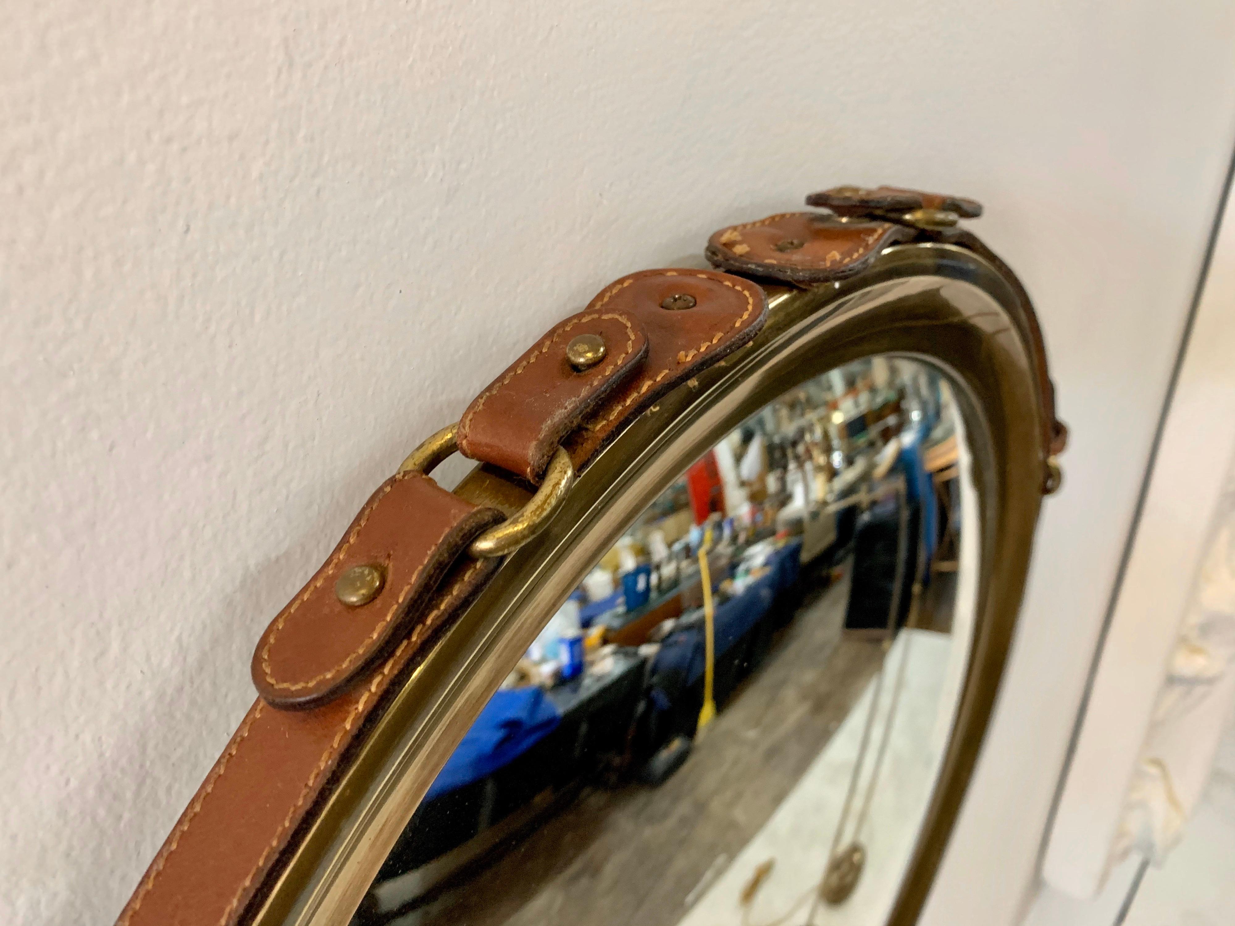 Vintage French, highly decorative Jacques Adnet stitched leather belt strap around brass frame convex mirror. ALL original and fine ready to use condition.