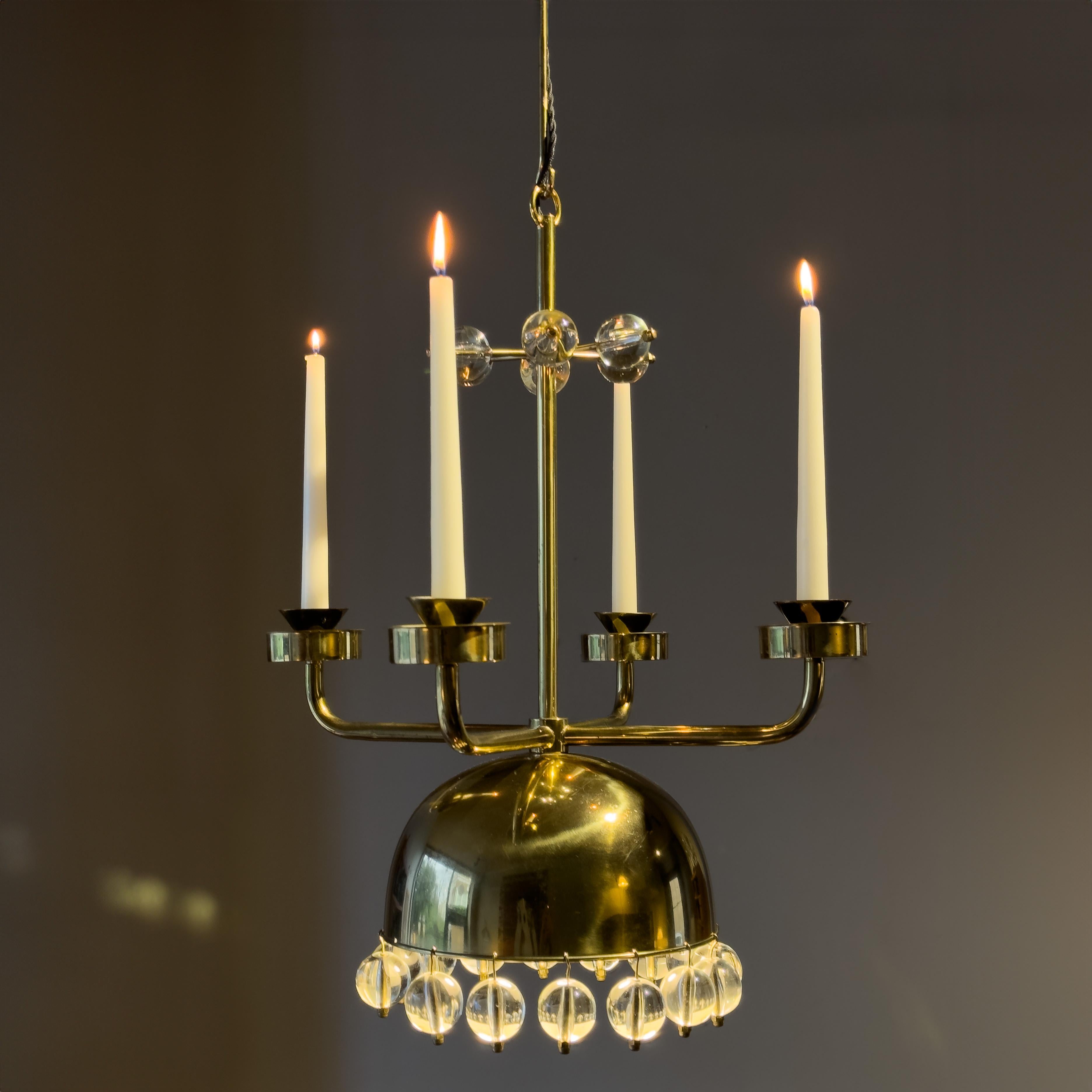 A rare, experimental chandelier designed during the 1960s by Swedish designer, Eric Högland, from the estate of Svend Lundh, founder of the furniture company founded in 1970, Källemo. Part candelabra, part electrical chandelier; this unusual pendant