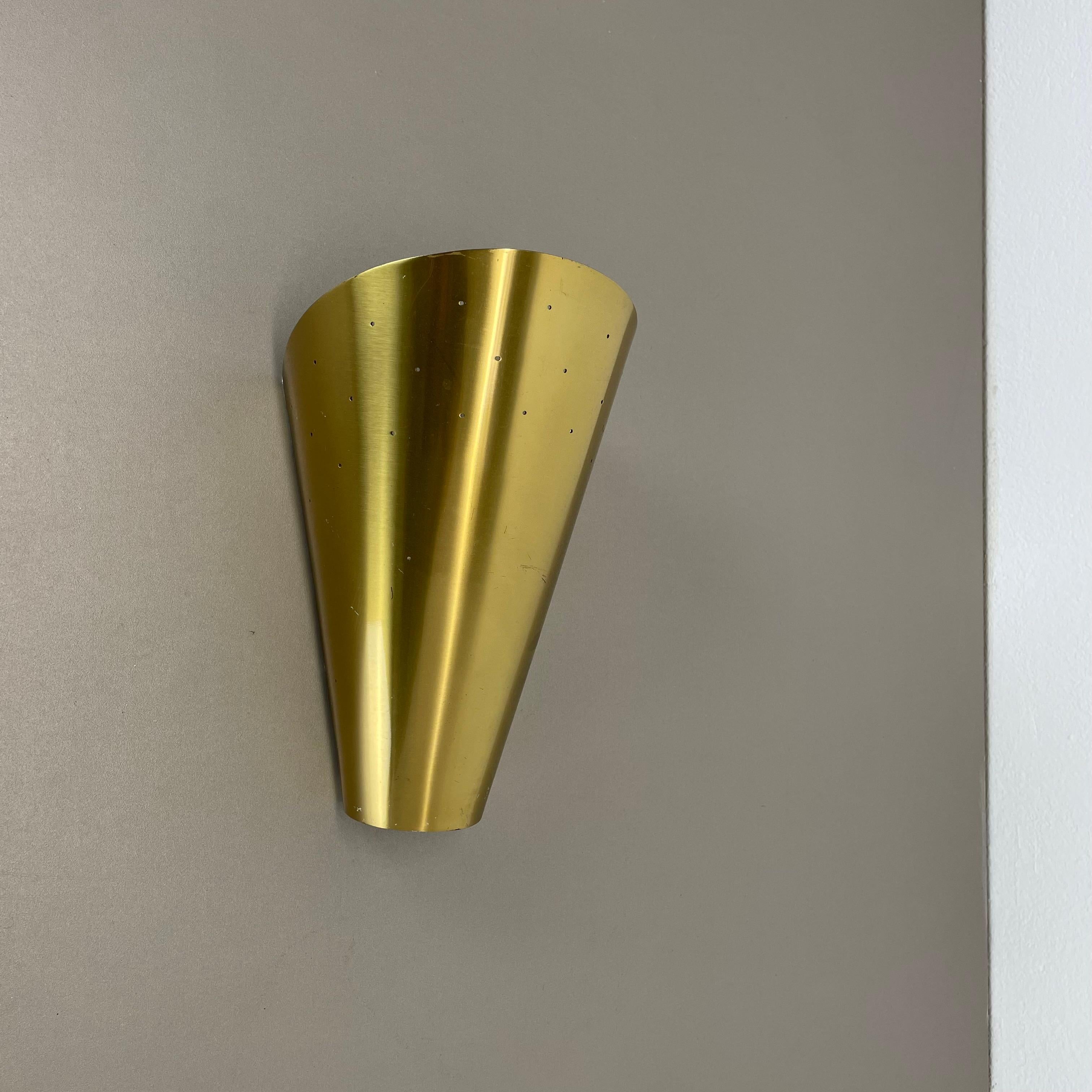 Article:

brass theatre wall light sconces



Origin:

Italy



Age:

1950s


This modernist light was produced in Italy in the 1950s in Italy. It is made of brass and metal with a large shade element on the front. it features a very unique hole