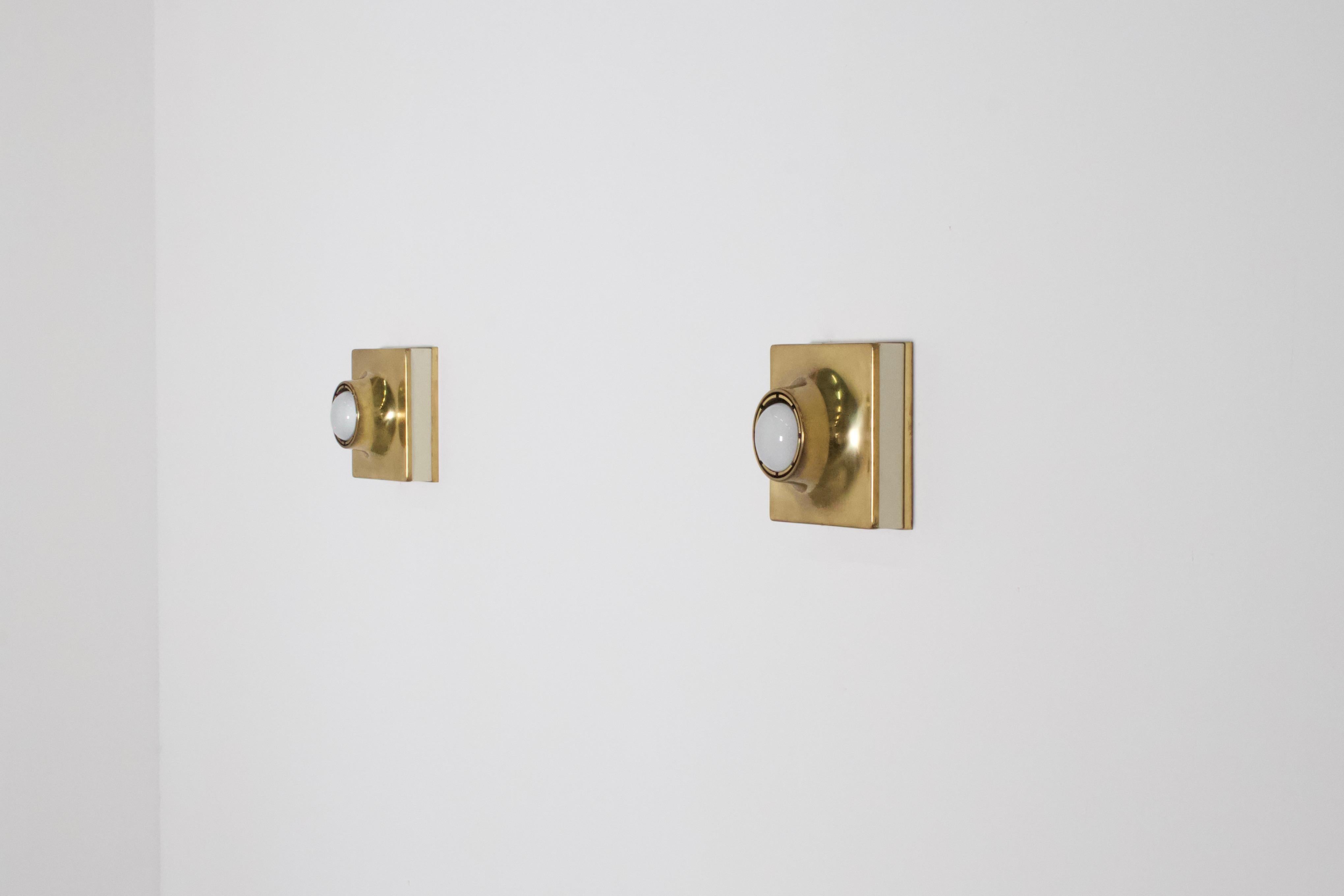 Rare high quality sconces / flush mounts in very good condition.

Manufactured in Italy, 1970s

4 available

The sconces are made of solid brass and white lacquered metal

They use one bulb up to 70 watts each and can be used as a flush mount or