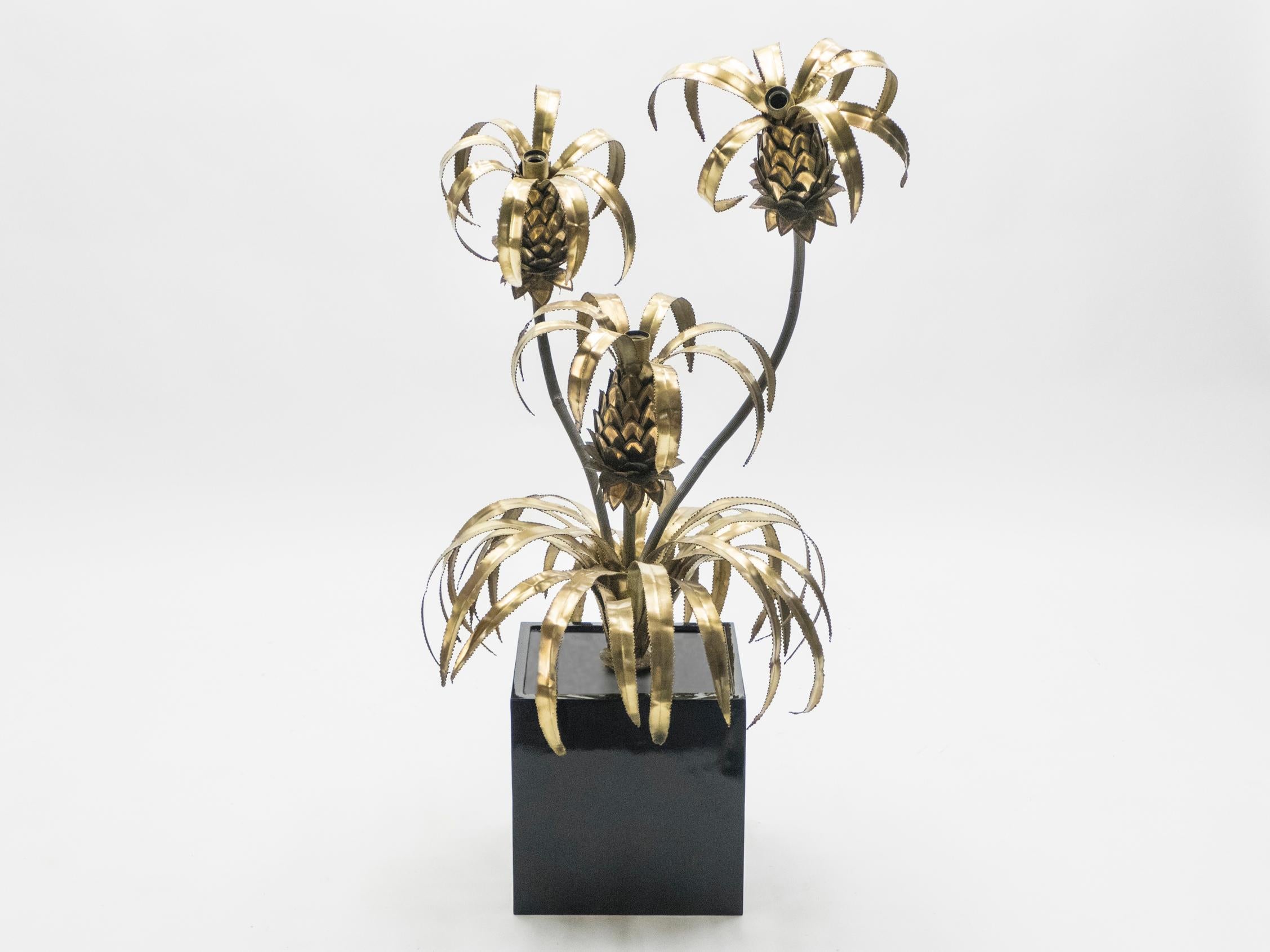 A rare floor lamp by renowned design firm Maison Jansen, created during the 1970s in France. The lamp is incredibly dynamic, featuring thin sheaves of bright brass peeling open like the leaves around pineapples, similarly made of brass. The first