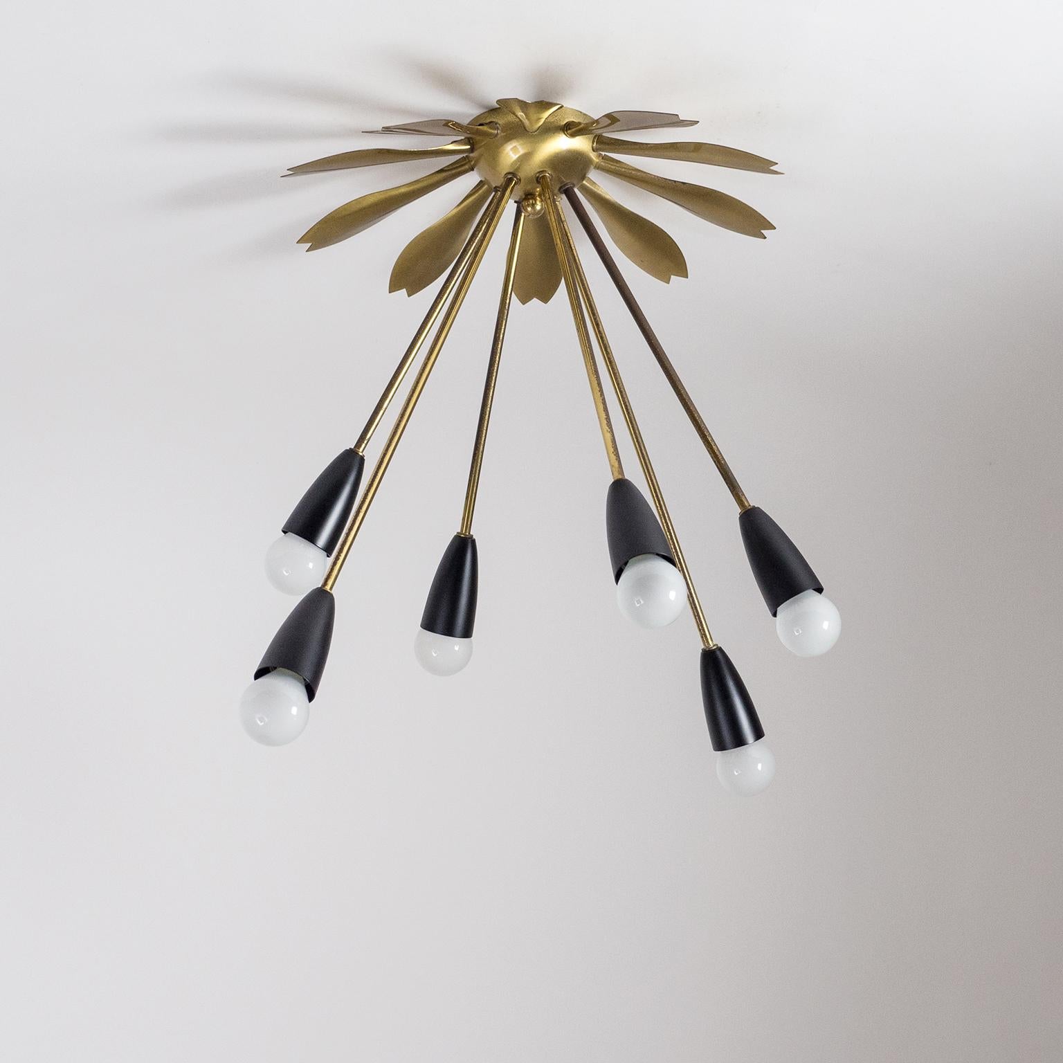 Very unique six-arm Sputnik flush mount from 1950s. The centerpiece which attaches to the ceiling is shaped in a sunburst motif with six brass arms in varying lengths emanating from its center like sun rays. This rare piece is made entirely of brass