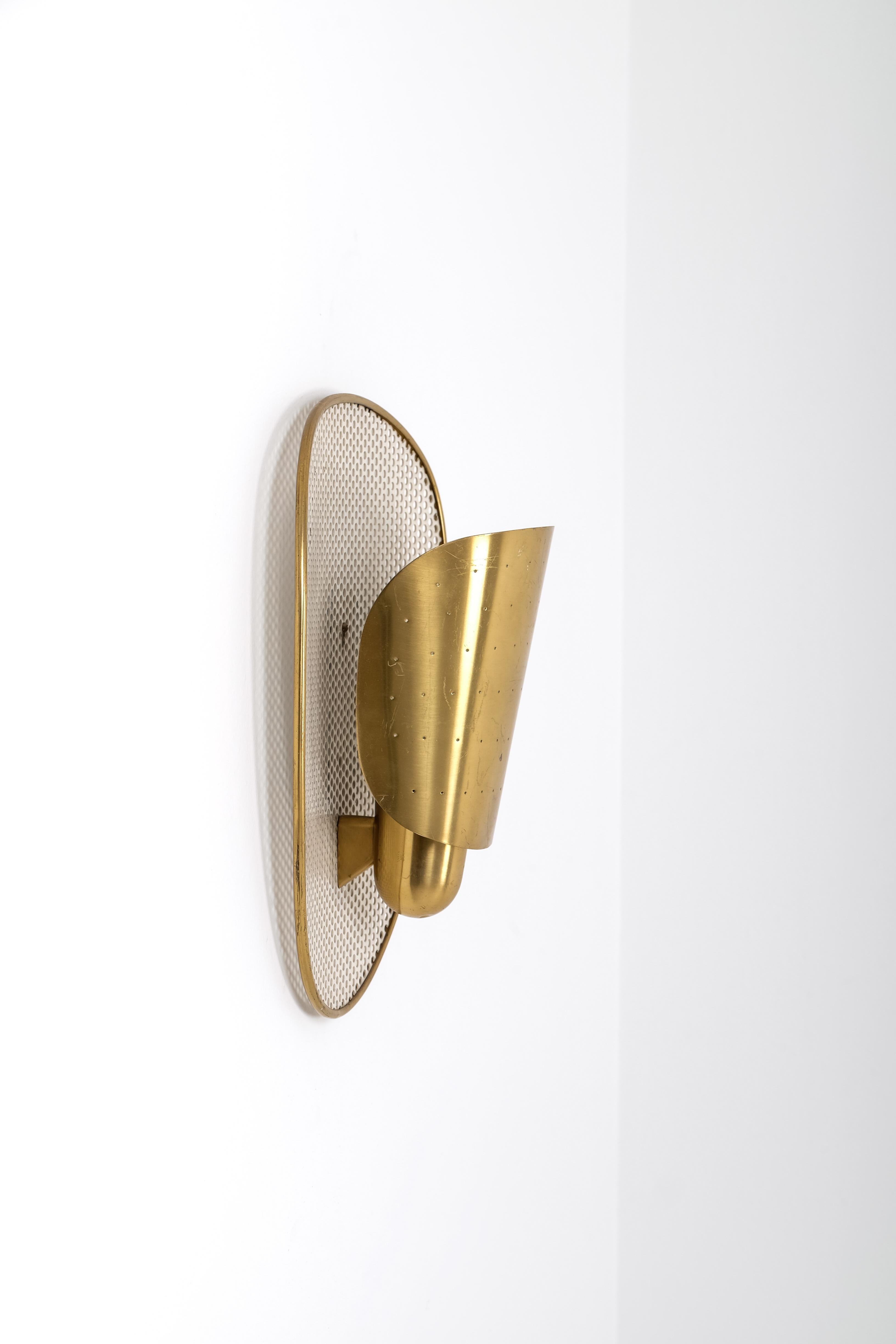 Rare wall lamp with perforated brass. Produced in Sweden by Ateljé Lyktan, 1950s. 
