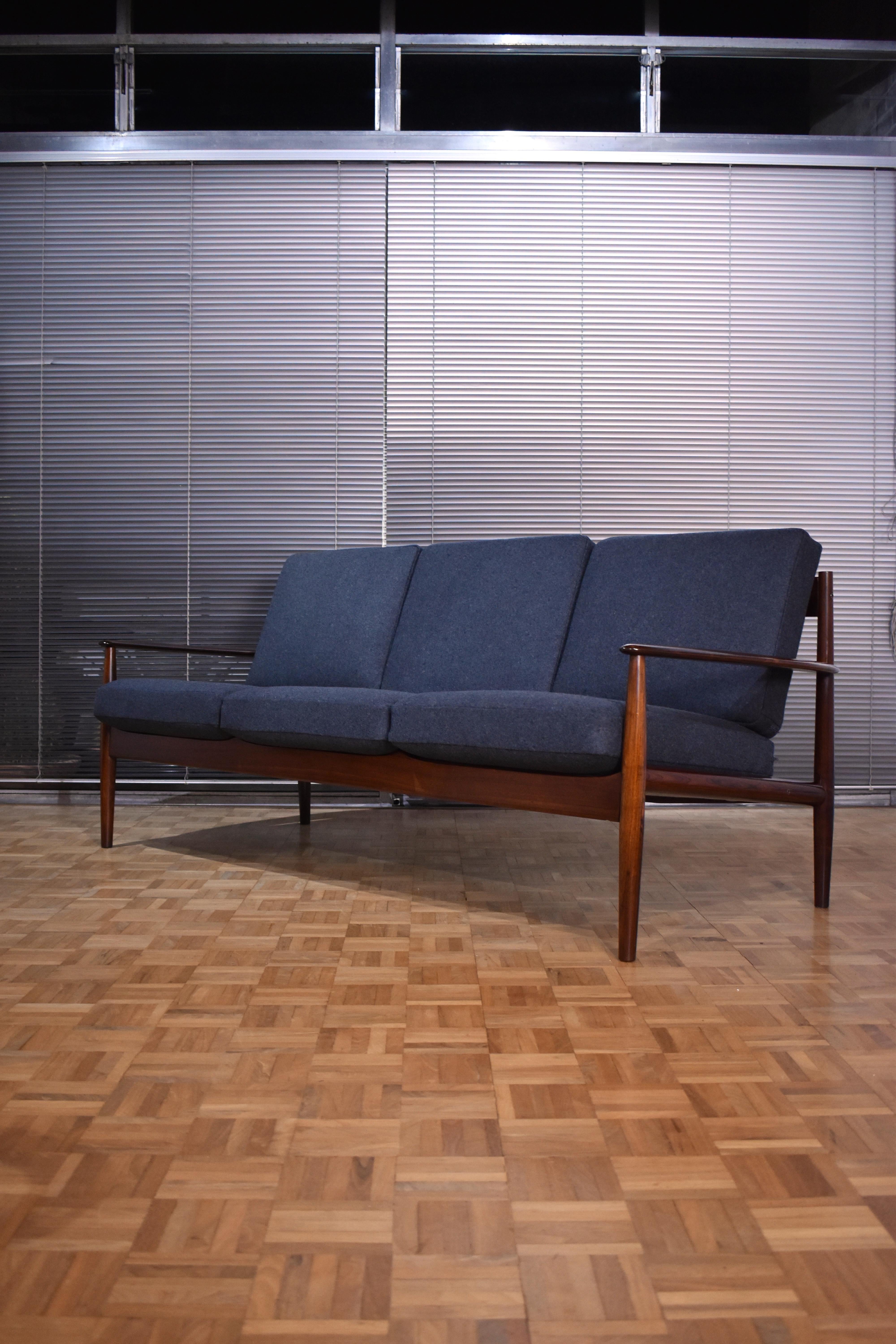 An absolutely stunning three seat sofa designed by Grete Jalk for France & Son, Denmark.

Only a small number of these sofas were produced in Rosewood in the mid to late 60's making them incredibly scarce. 

The Brazilian rosewood has