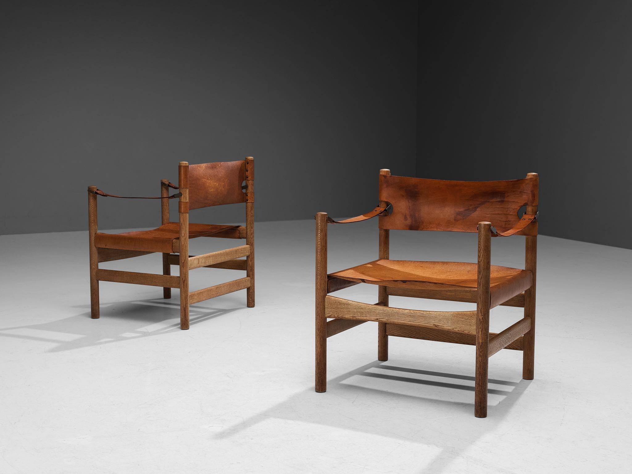 Børge Mogensen for Fredericia Stolefabrik, pair of ‘Safari’ armchairs model 2221, saddle leather, oak, brass, Denmark, 1960s

This rare pair of armchairs reminds of the classical foldable 'director-chairs', yet this design by Danish designer Børge