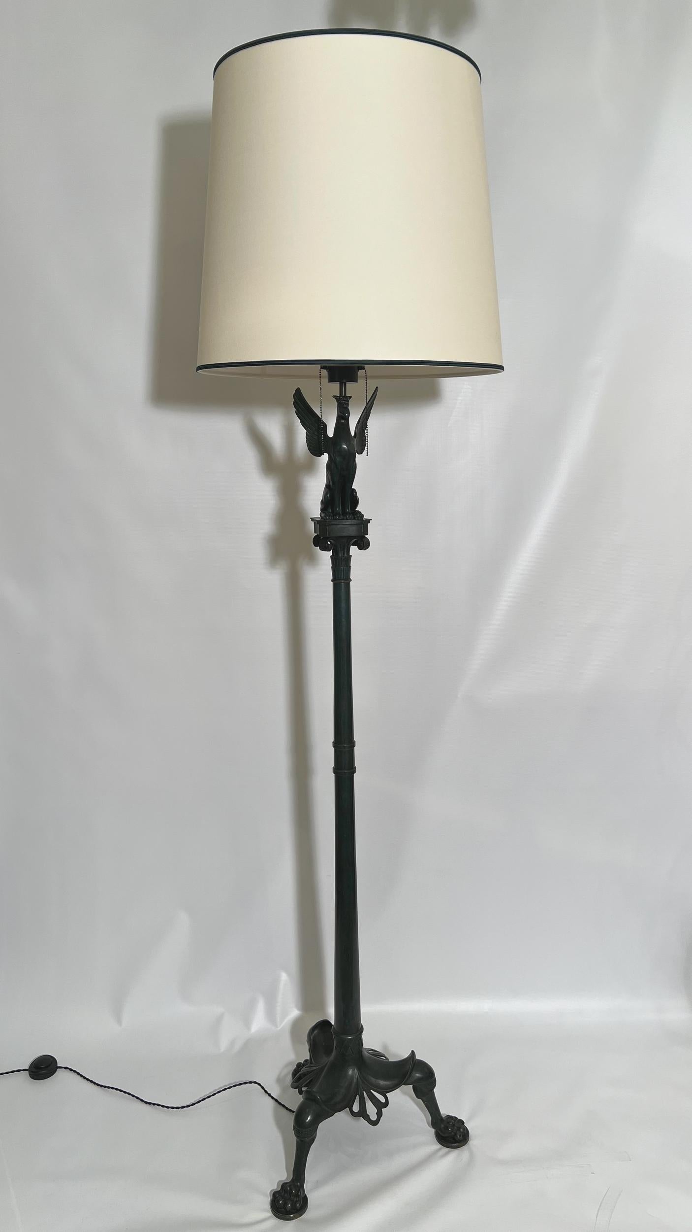 Rara lampada da terra in bronzo con patina verde, in stile neoclassico.

Fusto a doppio anello sormontato da un capitello corinzio che sostiene una chimera alata, seduta, con le ali spiegate. Piede tripode, zoomorfo, che termina con tre zampe di