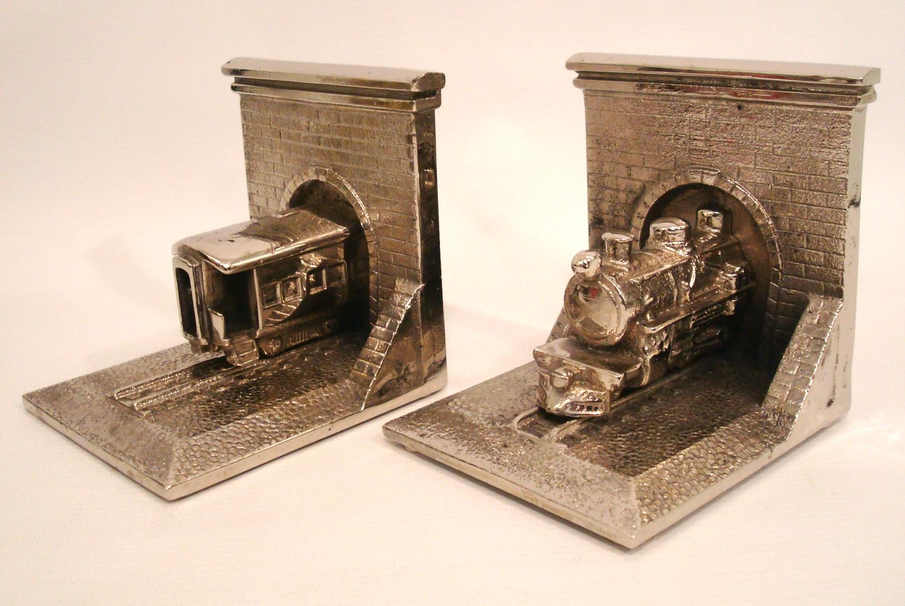 Nice & Rare Silvered Bronze Train Locomotive Bookends 1940´s.
Heavy Bookends. Hight quality.  Train entering a tunel. 

We have specialized in the sale of Art Deco and Art Nouveau and Vintage styles since 1995. If you have any questions we are at