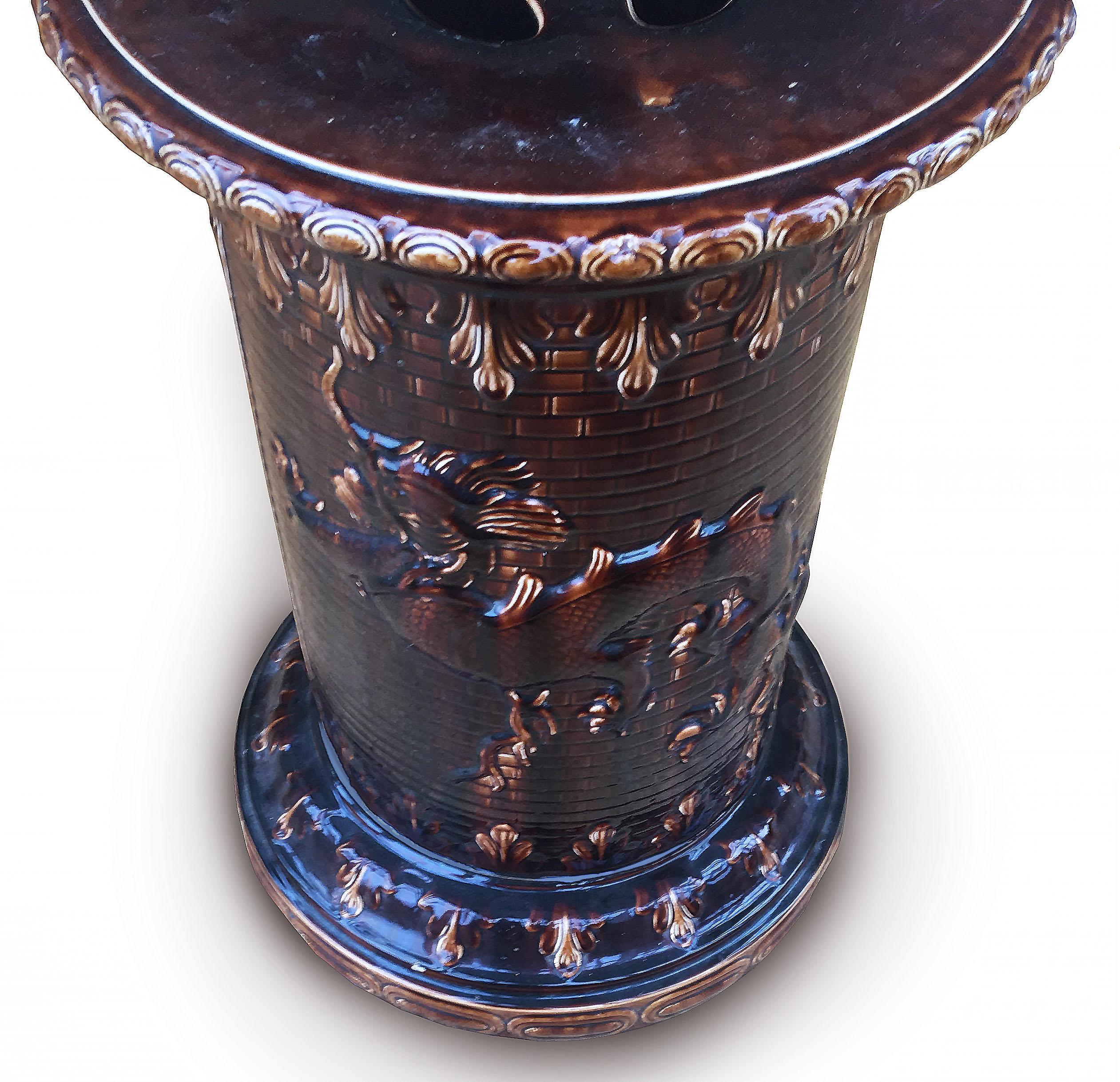 Rare 19th century brown glazed Majolica dragon pedestal circa 1890 after Christopher Dresser,
The circular brown glazed body decorated with a fierce Chinese style dragon against brick work, the dragon design seen on Minton pieces designed by