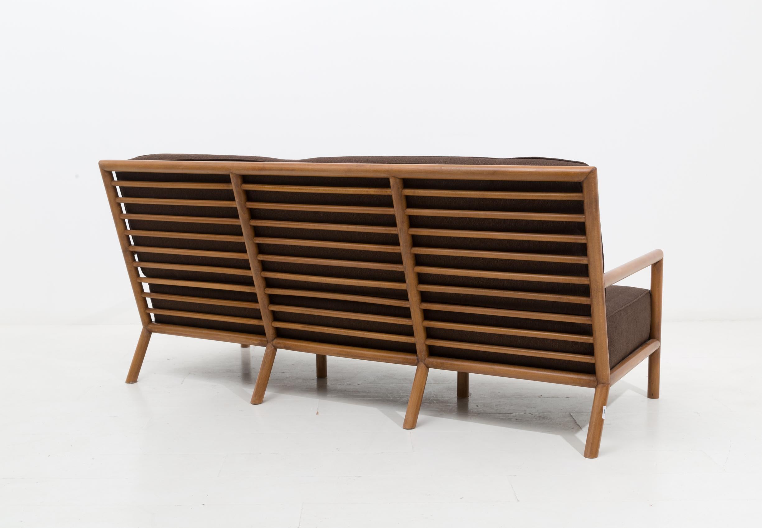 Rare and beautiful sofa designed by T.H. Robsjohn-Gibbings in 1950.
The sofa was made with light walnut wood, the back has tubular slats that make the structure more solid and comfortable. Two large cushions, which allow a soft and very comfortable