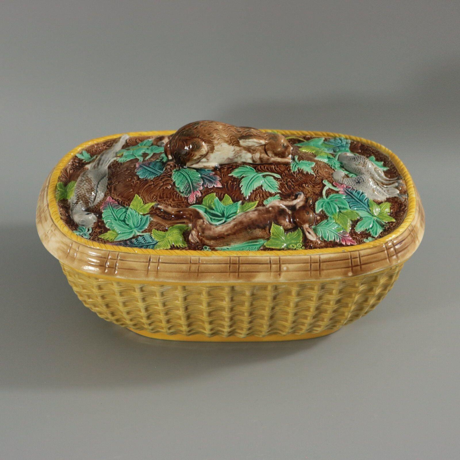 Brown Westhead Moore and Co Majolica game pie dish which features a crouching rabbit knop, surrounded by various game and leaves. Basketweave base. Colouration: yellow, brown, green, are predominant. Bears a pattern number, '571 and 3'.