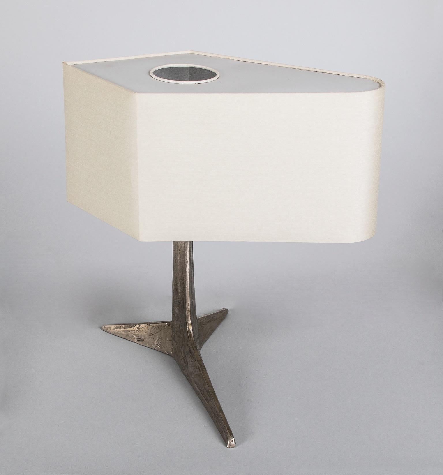 Felix Agostini (1910 - 1980) 

Une rare lampe de table sculpturale Brutalist de Felix Agostini, en bronze nickelé texturé avec une base tripartite abstraite en forme de griffe rappelant Diego Giacometti, surmontée d'un abat-jour architectural en
