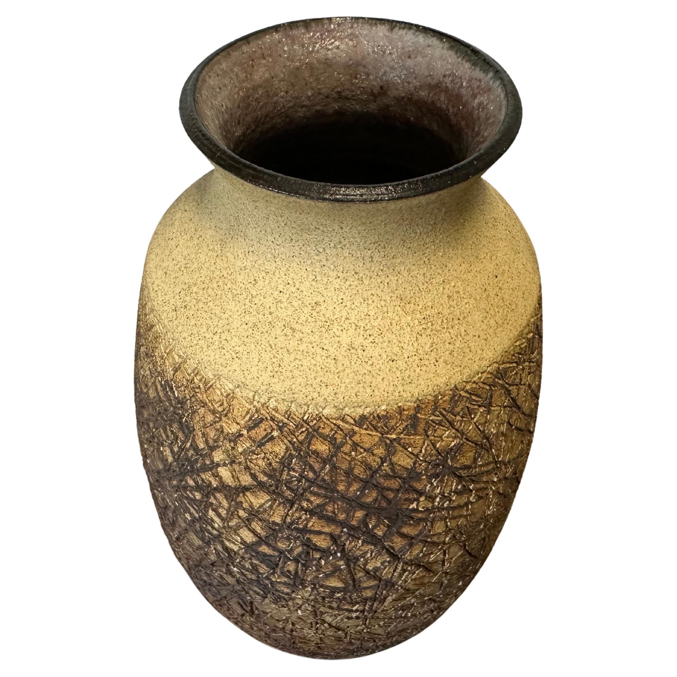 Rare Brutalist studio pottery stoneware vase by Sally Hare Leibold, circa 1970s. An interesting, cool and different piece that is made of stoneware pottery, characterized by its earthy tones and a distinctly textured glaze on the lower portion,