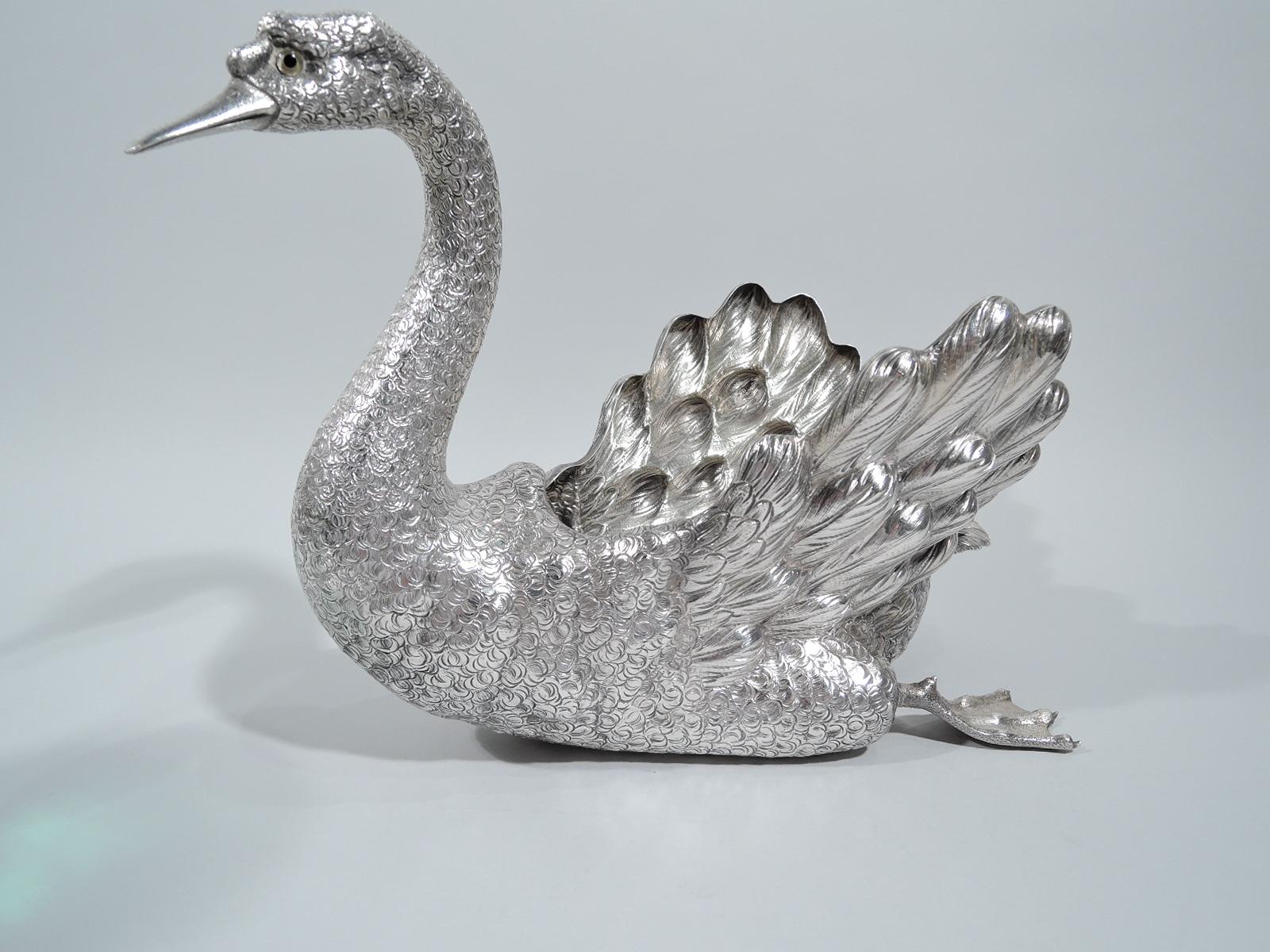 Majestic sterling silver swan bowl. Hollow body, scrolled neck, pointed bill, intent glass eyes, and paddling webbed feet. Realistic plumage from scaly to fluffy. A big bird centerpiece to grace your next dinner party. Marked “Buccellati / Italy /