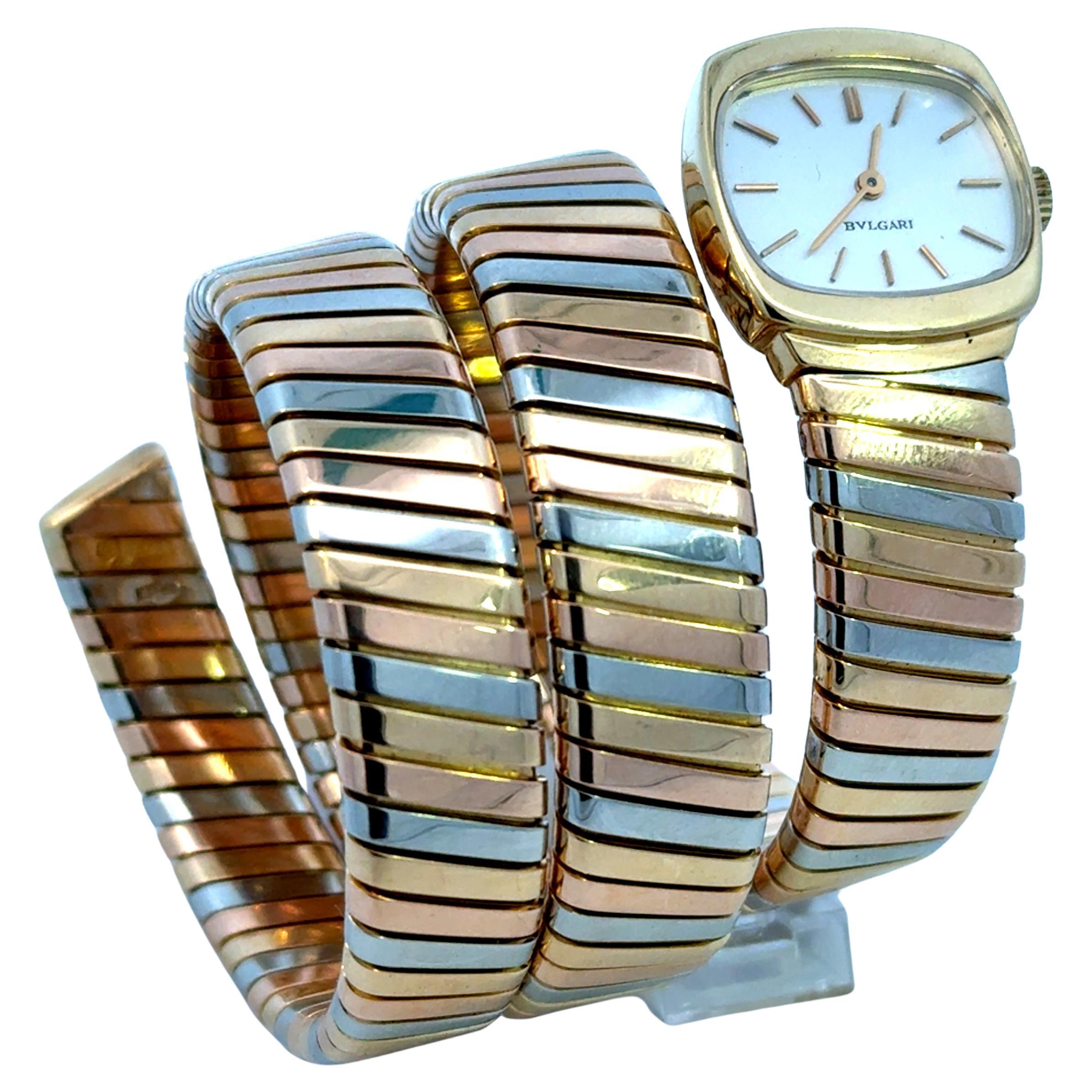 Rare Bulgari Tubogas lady's snake bracelet watch in 18k yellow, white, and pink gold. 
This Manual winding  watch has unusual and rare squarish  head and pristine white dial. 
An iconic watch you will wear forever. 
1975 circa.
Similar reference can