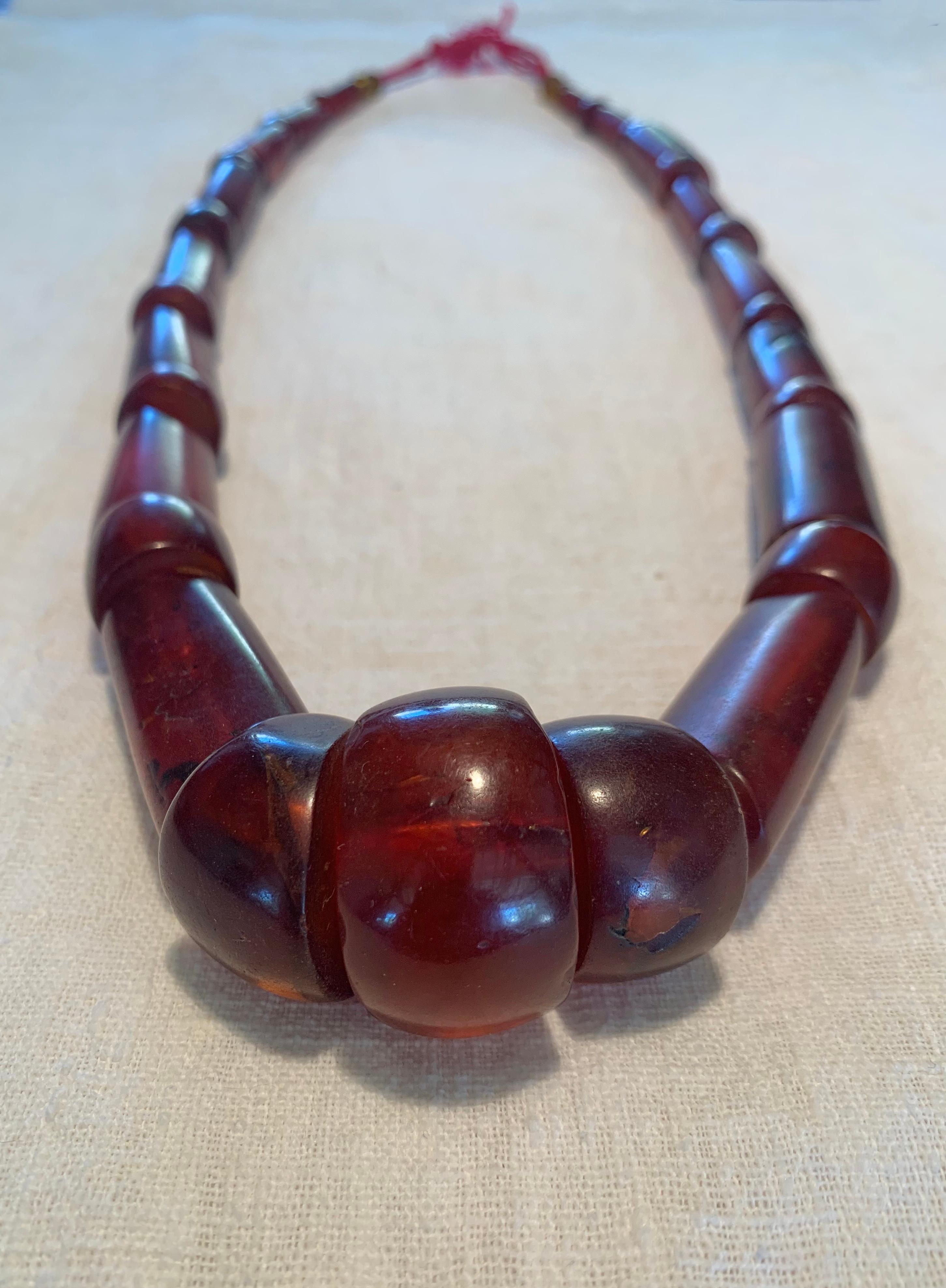 This Burmese Mizoram necklace features long, cylindrical reddish-brown amber beads. This type of amber is Burmite, a type of fossilised amber that originates from the Kachin State of modern day Myanmar. This necklace was once worn by a Mizo woman,